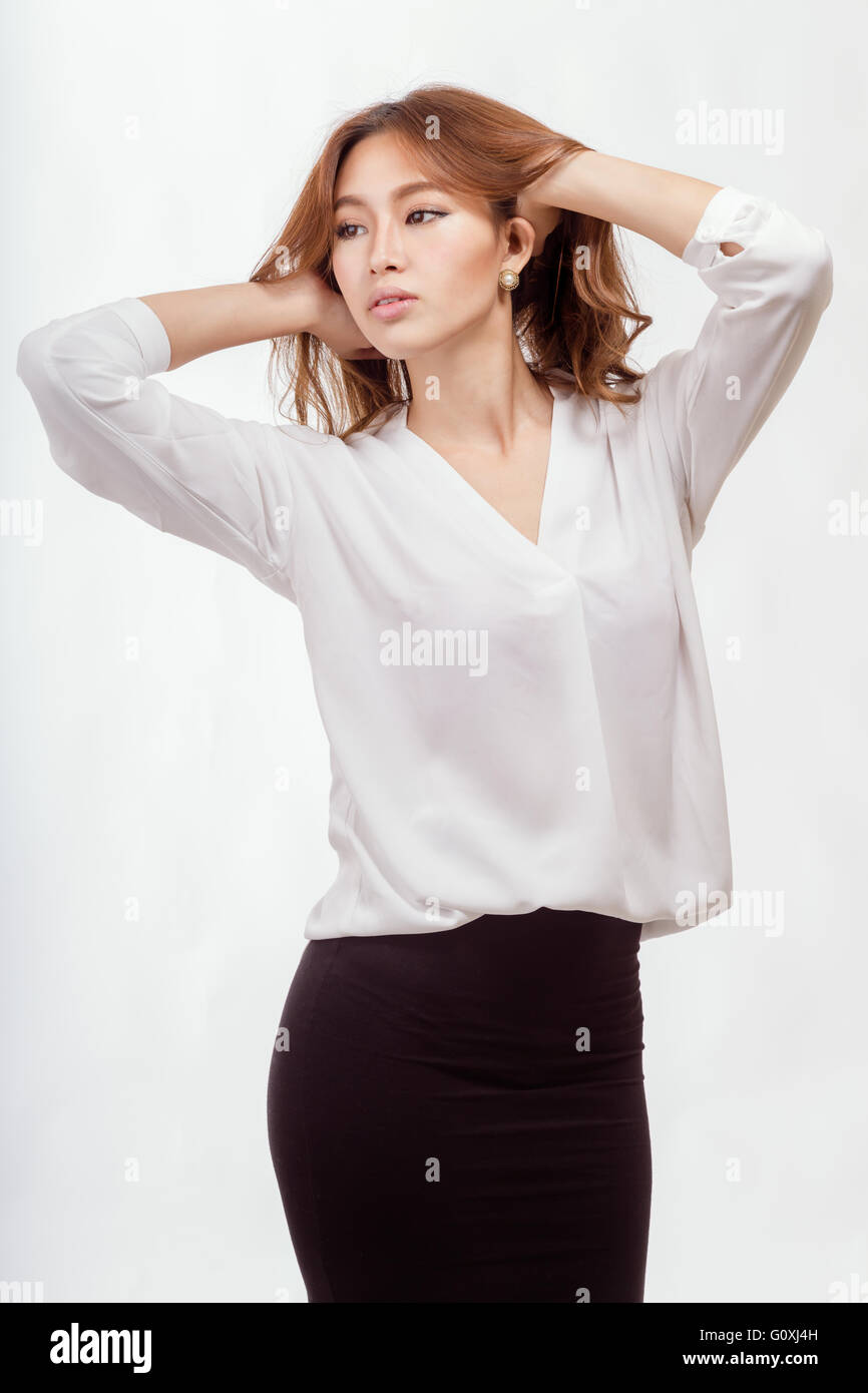 Attraente americano asiatico imprenditrice in camicia bianca e gonna nera  con le mani nei capelli Foto stock - Alamy