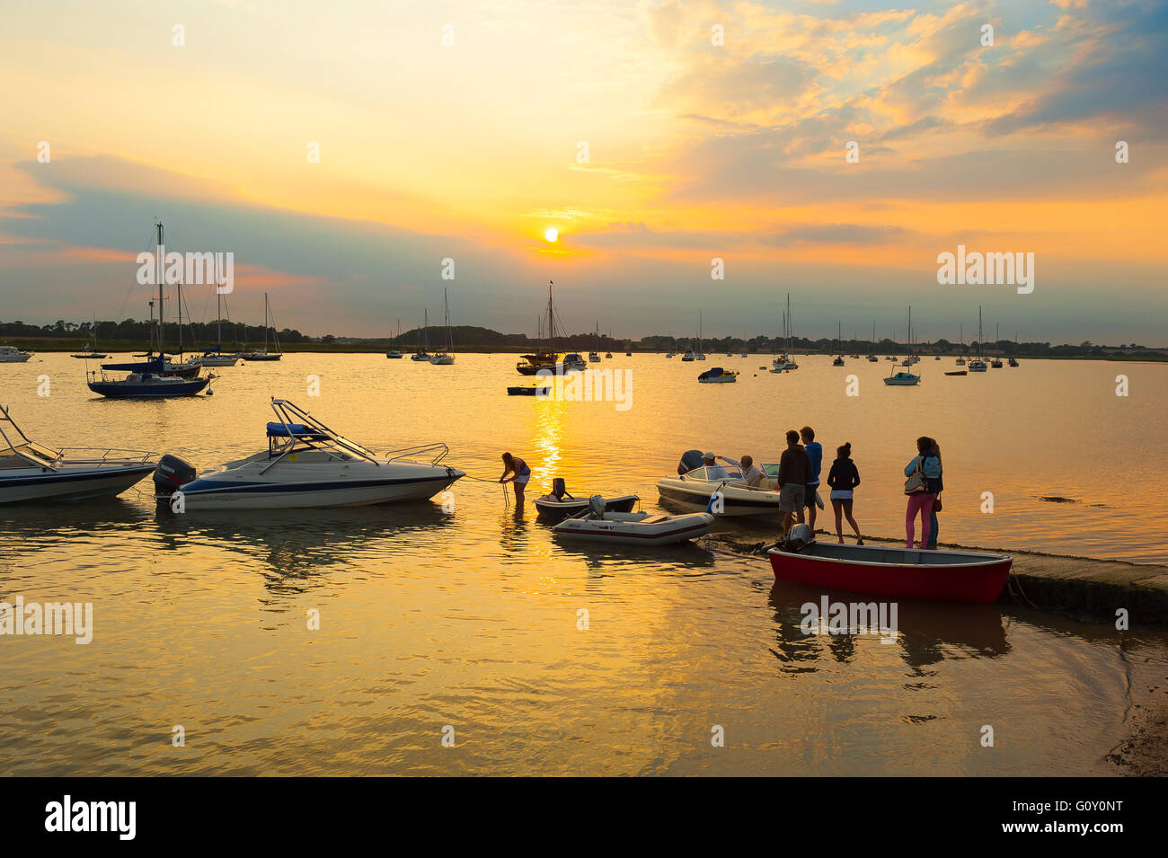 Paesaggio estivo del fiume Suffolk, vista delle persone in una serata estiva in piedi su un piccolo molo di legno nel fiume Deben, Ramsholt, Suffolk, Inghilterra, Regno Unito Foto Stock