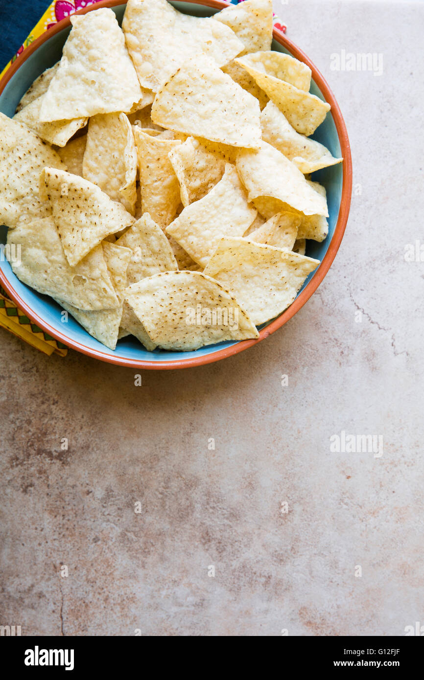 Ciotola di freschi tortilla chips sulla superficie di pietra con una copia dello spazio. Vista da sopra Foto Stock