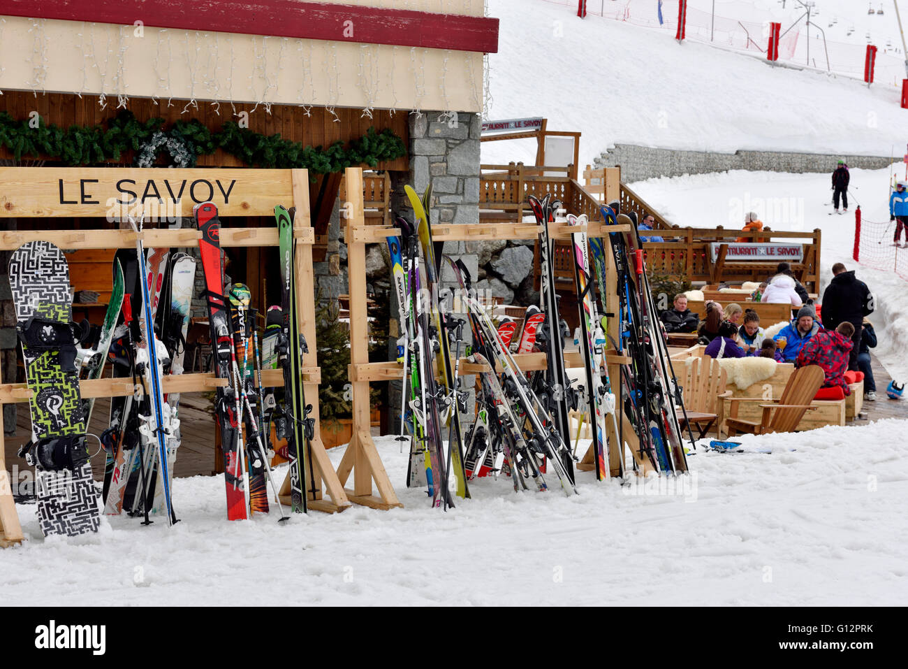 Sci e snowboard in appoggio contro di legno i portasci durante la pausa di Les Arcs, Francia Foto Stock