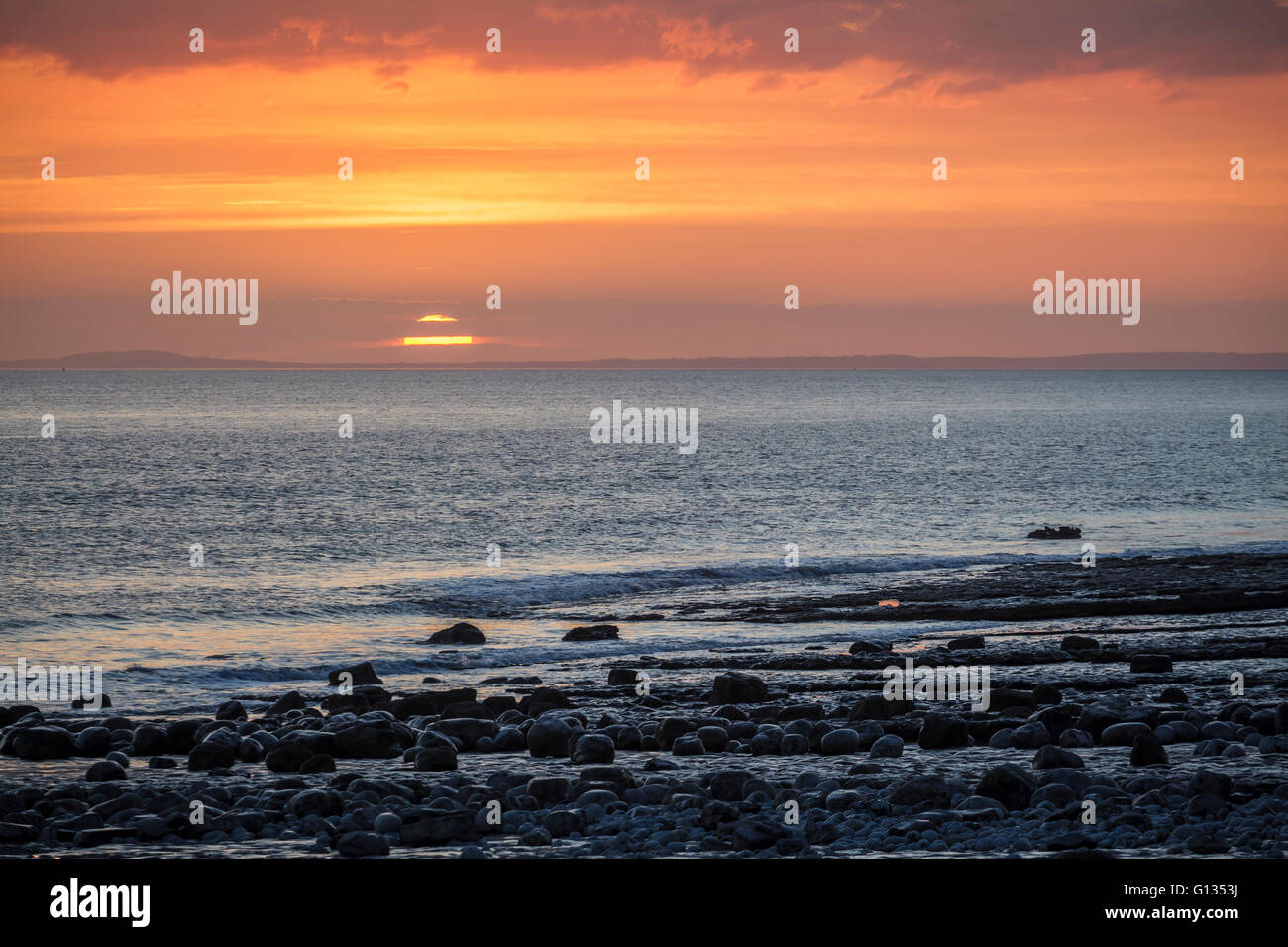 Regolazione del sole sopra il canale di Bristol dall'Glamorgan Heritage costa a Cwm Nash Beach, Galles del Sud Foto Stock
