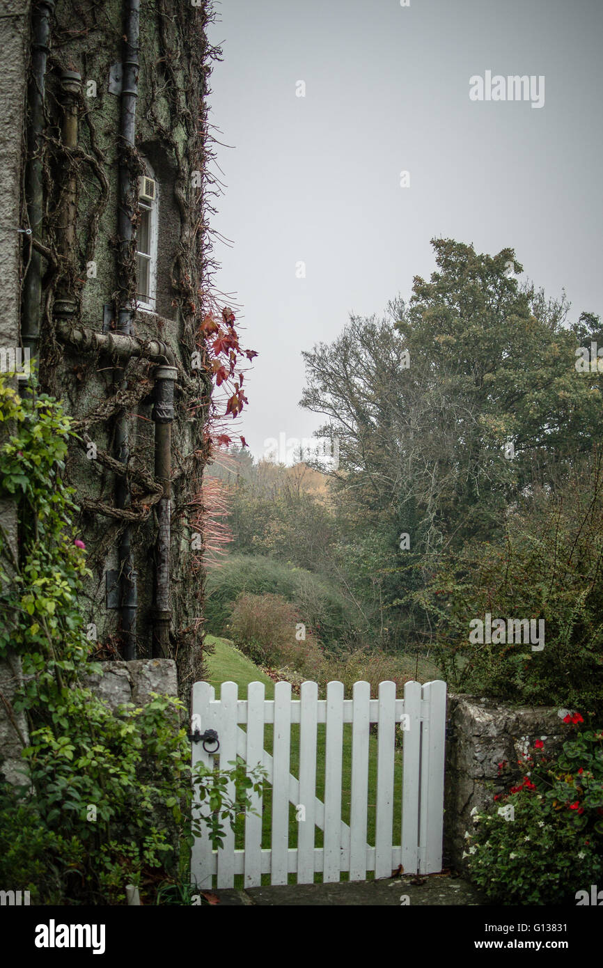 Piccolo cancello bianco che conduce alla coppia dei giardini formali dietro Fonmon Castello sulla giornata d'autunno. Foto Stock