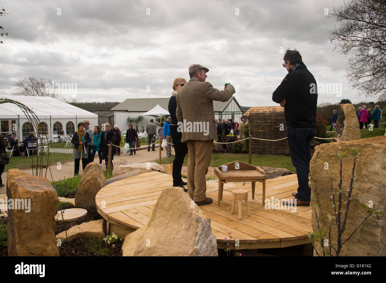 Molla di Harrogate Flower Show 2016 (North Yorkshire, Inghilterra) - su legno decking, un paio di ascoltare un uomo dando una vendita di passo in una mostra del giardino. Foto Stock