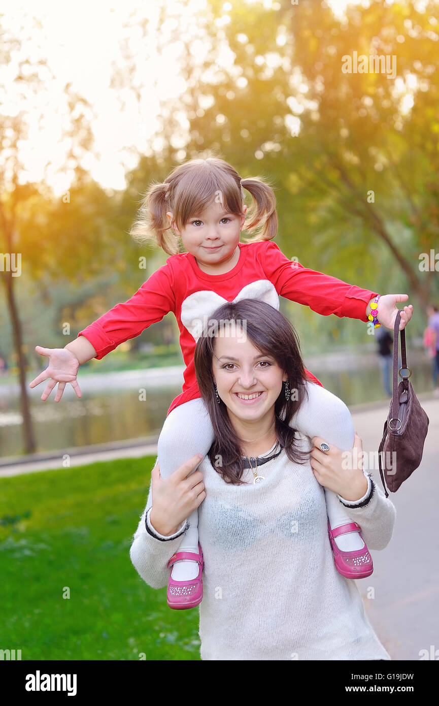 Giovane madre e il suo bambino ragazza divertirsi in autunno Foto Stock