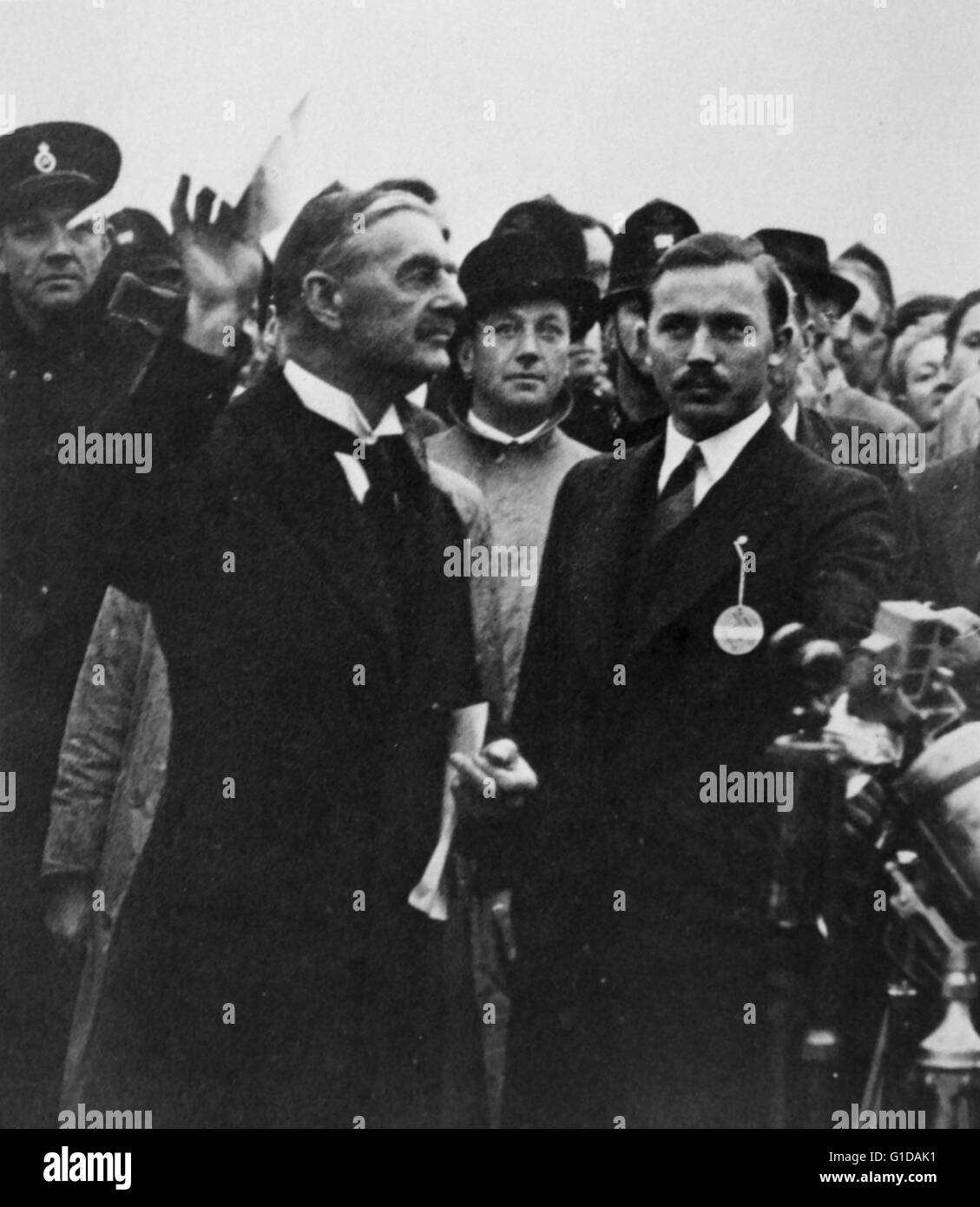 Neville Chamberlain (Primo Ministro britannico ritorna dalla firma dell'accordo di Monaco di Baviera 1938. L accordo è stato un insediamento permettendo la Germania nazista di annessione di porzioni della Cecoslovacchia, è ampiamente considerato come un errore di atto di pacificazione verso la Germania. L accordo è stato firmato nelle prime ore del 30 settembre 1938 Foto Stock