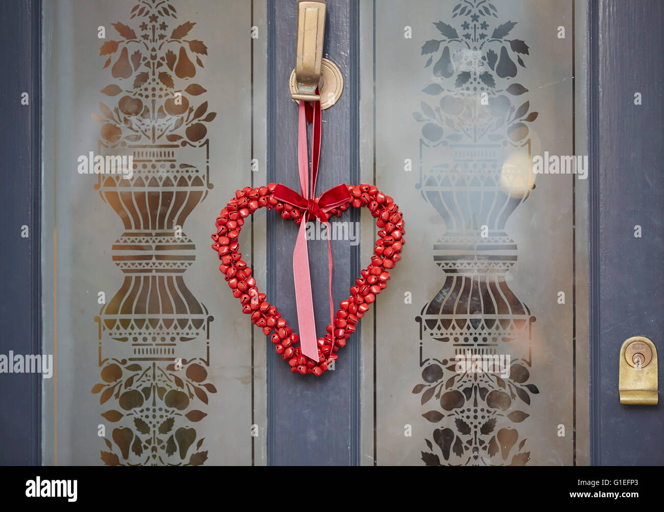 Ghirlanda di Natale sulla porta. A forma di cuore ad garland appeso sulla porta ornati. Foto Stock