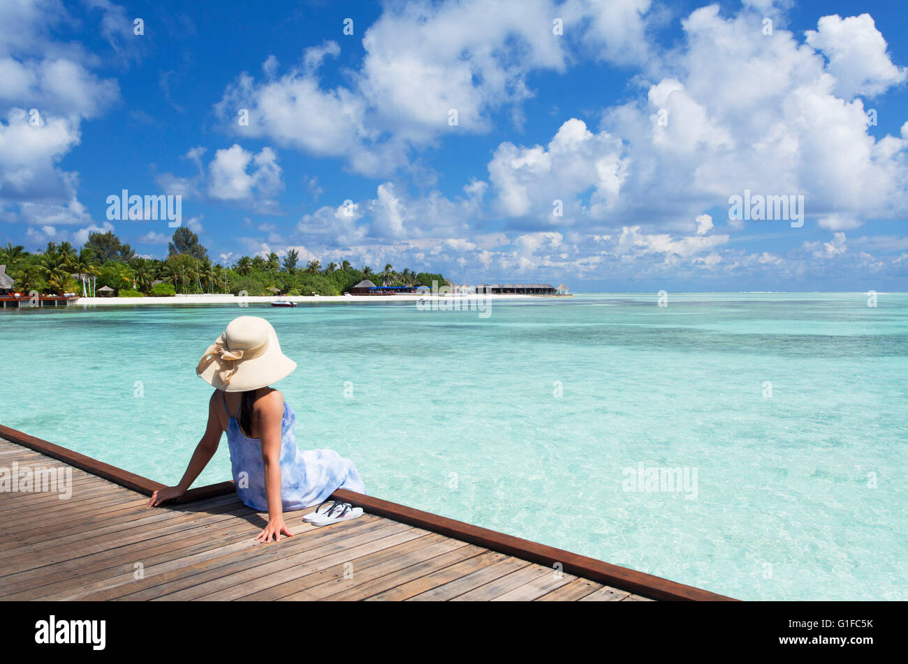 Donna sul molo Olhuveli Beach and Spa Resort South Male Atoll, Kaafu Atoll, Maldive Foto Stock
