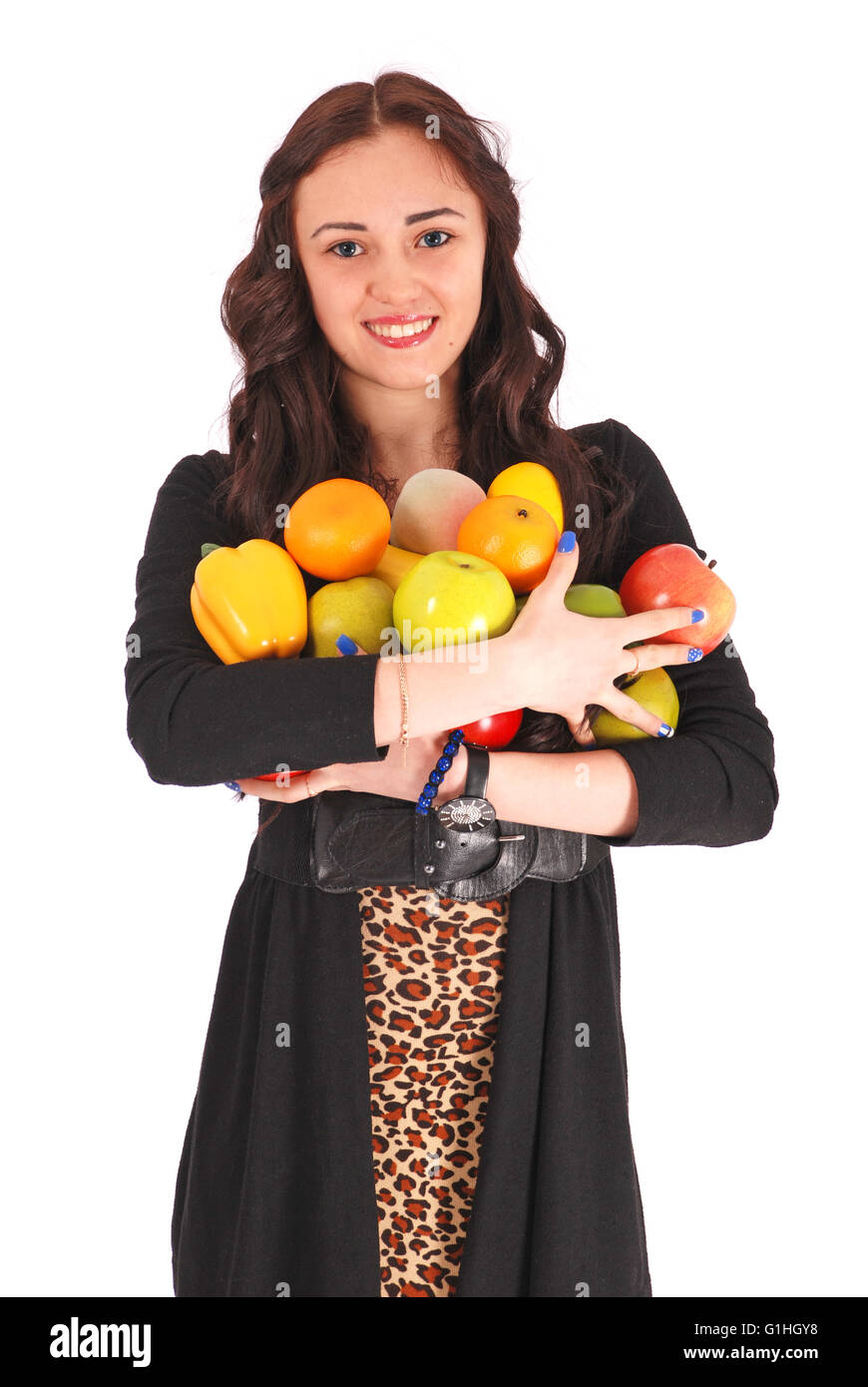 Ragazza-adolescente tiene in mano un frutto isolato su bianco Foto Stock