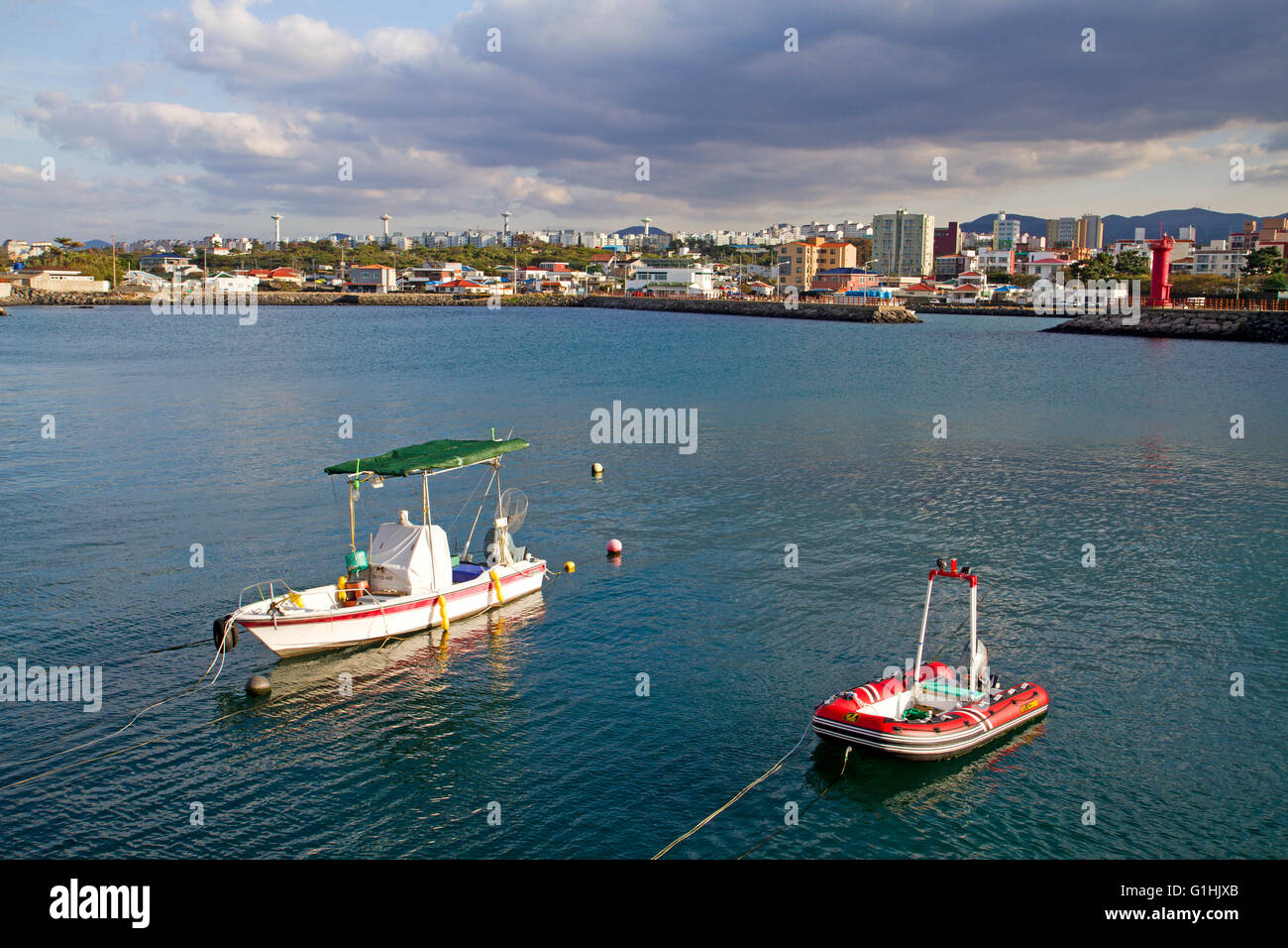 Barche e avvicinando tempesta su Jeju City Foto Stock