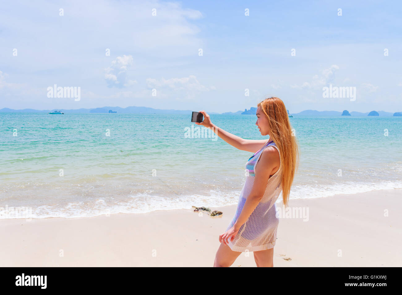 Felice attraente bionda in bikini prendendo un auto immagine su una bellissima spiaggia Sunny Beach Foto Stock