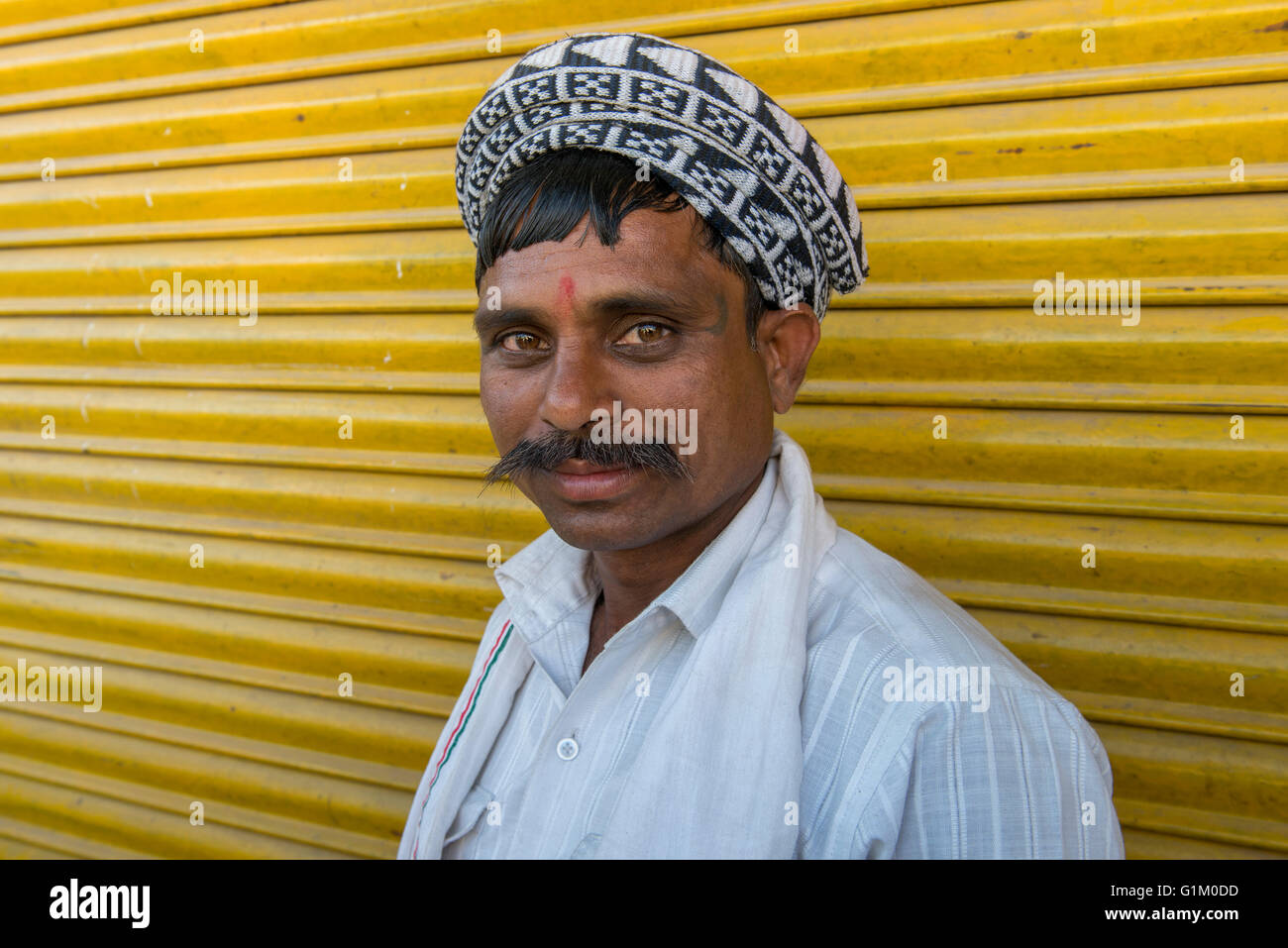 Uomo alla fiera locale contro sfondo giallo, Havelikheda Village, Madhya Pradesh Foto Stock
