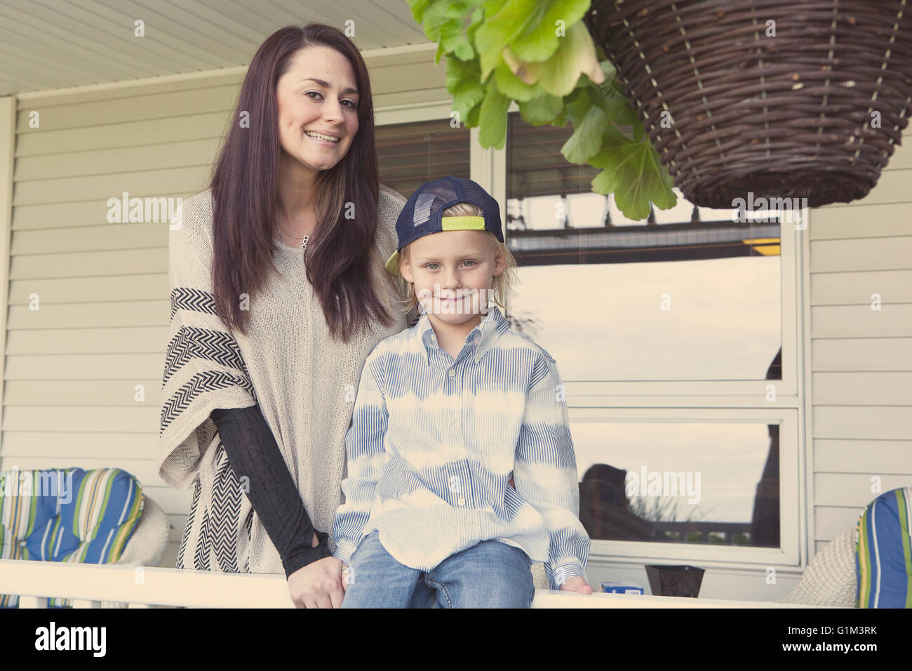 Caucasian madre e figlio sorridente sul portico Foto Stock