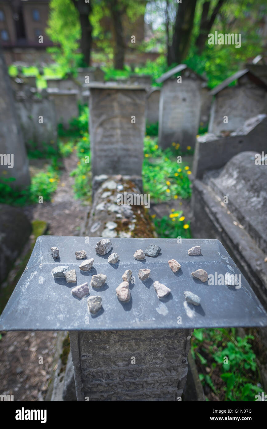 Cimitero ebraico di Cracovia, pietre poste come marcatori di rispetto su una lapide nel cimitero sinagoga Remuh nel quartiere Kazimierz di Cracovia, Polonia Foto Stock