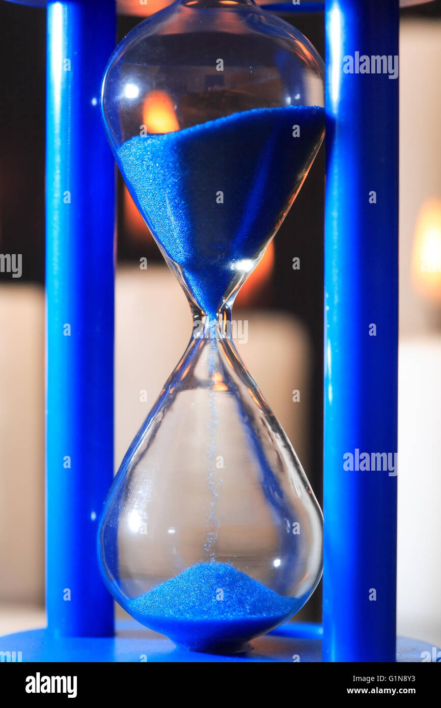 Extreme closeup di blu vintage clessidra con flusso di sabbia Foto Stock