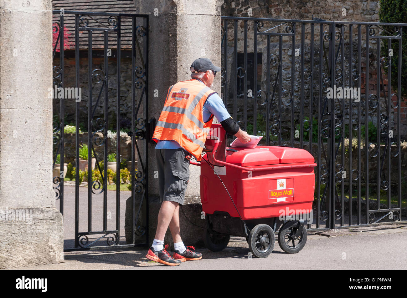 Royal Mail portalettere facendo il suo giro con carrello postale, High Street, Thame, Oxfordshire, England, Regno Unito Foto Stock