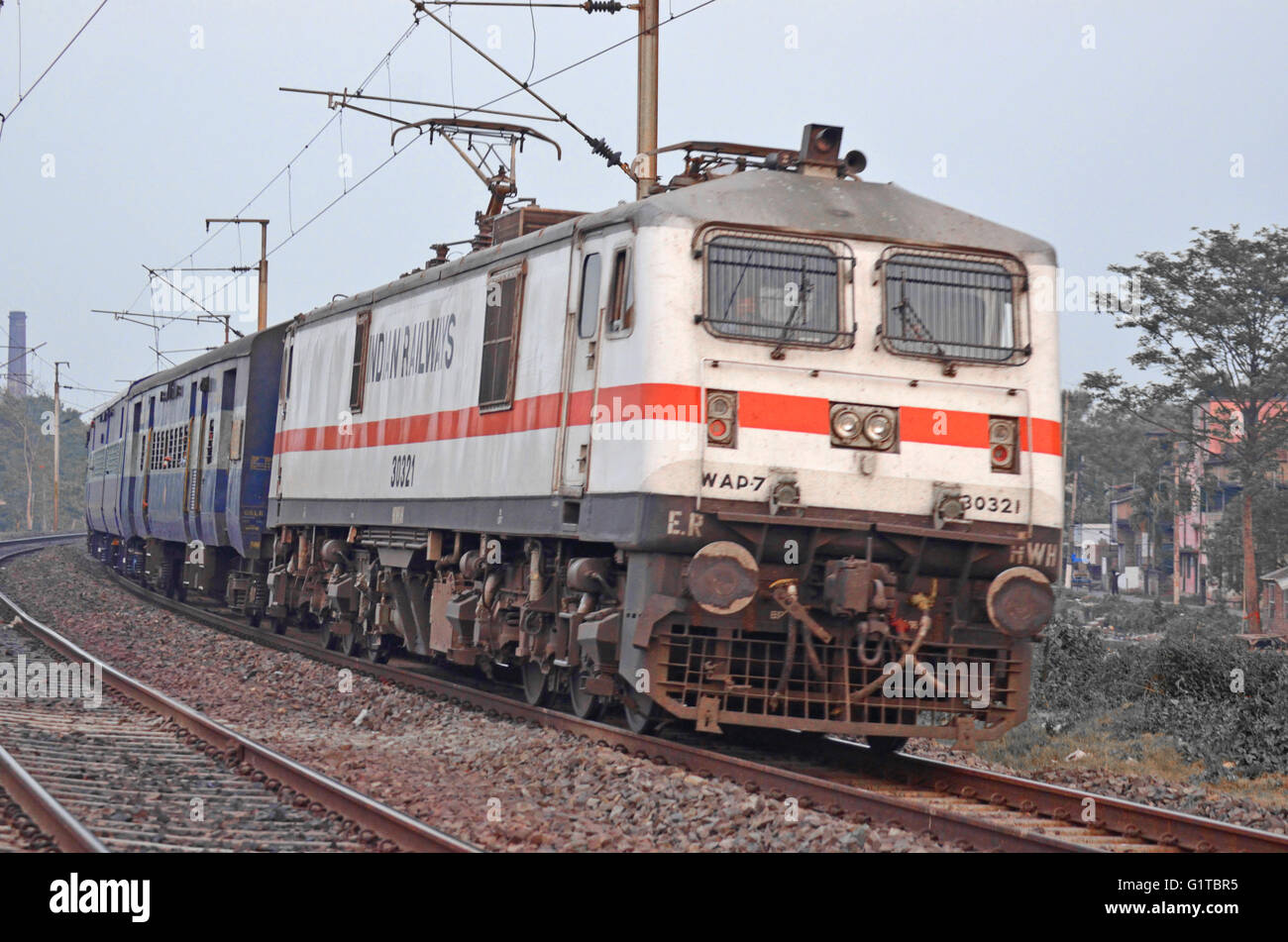Il WAP-7 classe locomotiva elettrica bacino di bolina Express rolling out di una curva, vicino a Kolkata, Ferrovie indiano, India Foto Stock