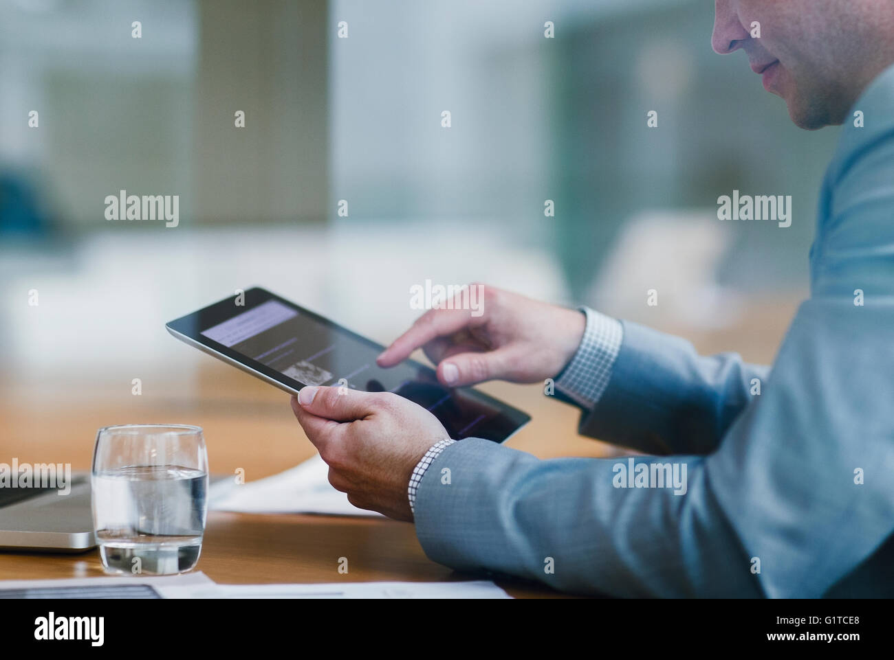 Imprenditore con tavoletta digitale in ufficio Foto Stock