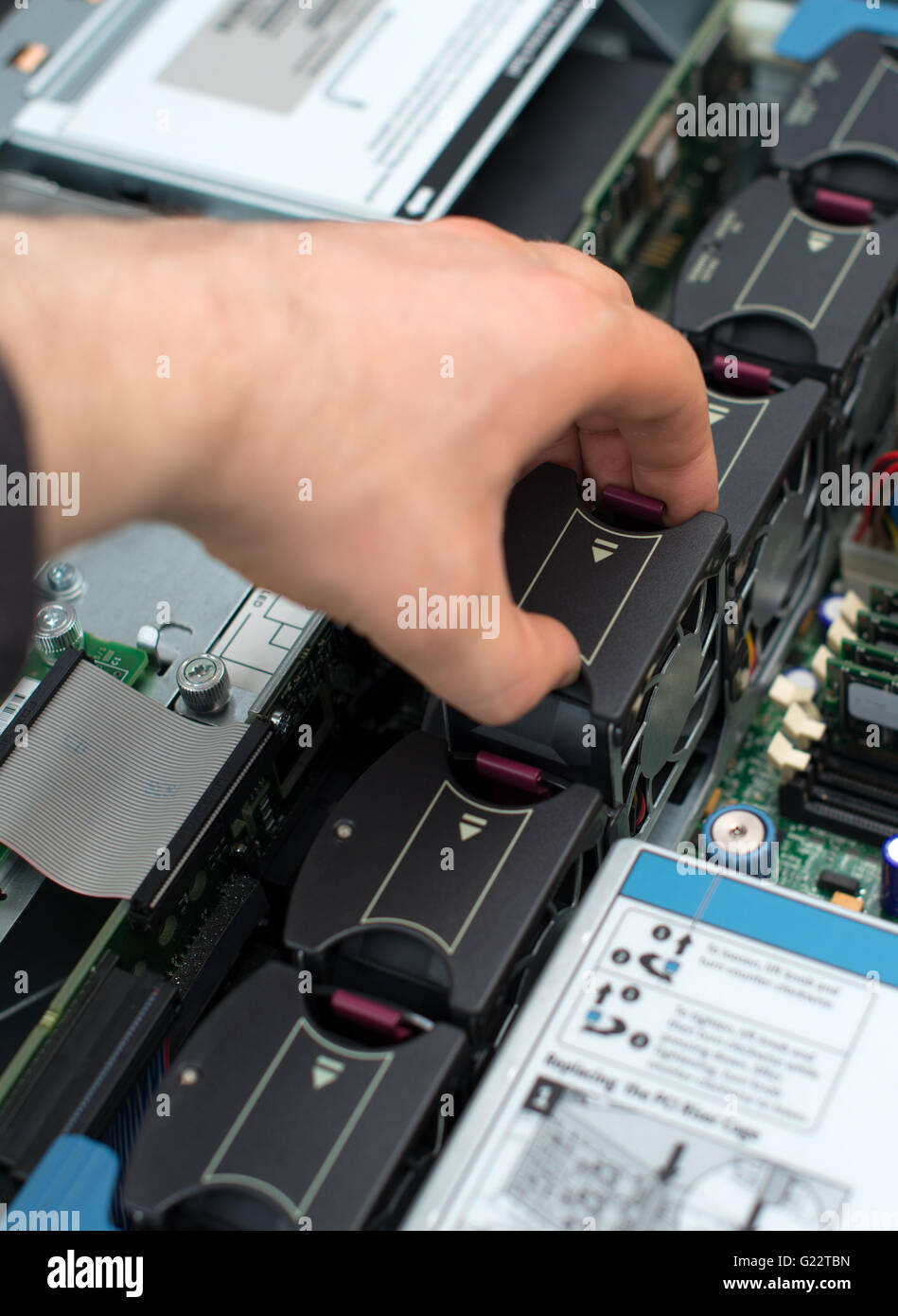 Tecnico informatico Installazione ventola dello scambiatore di calore nella scheda madre. Foto Stock