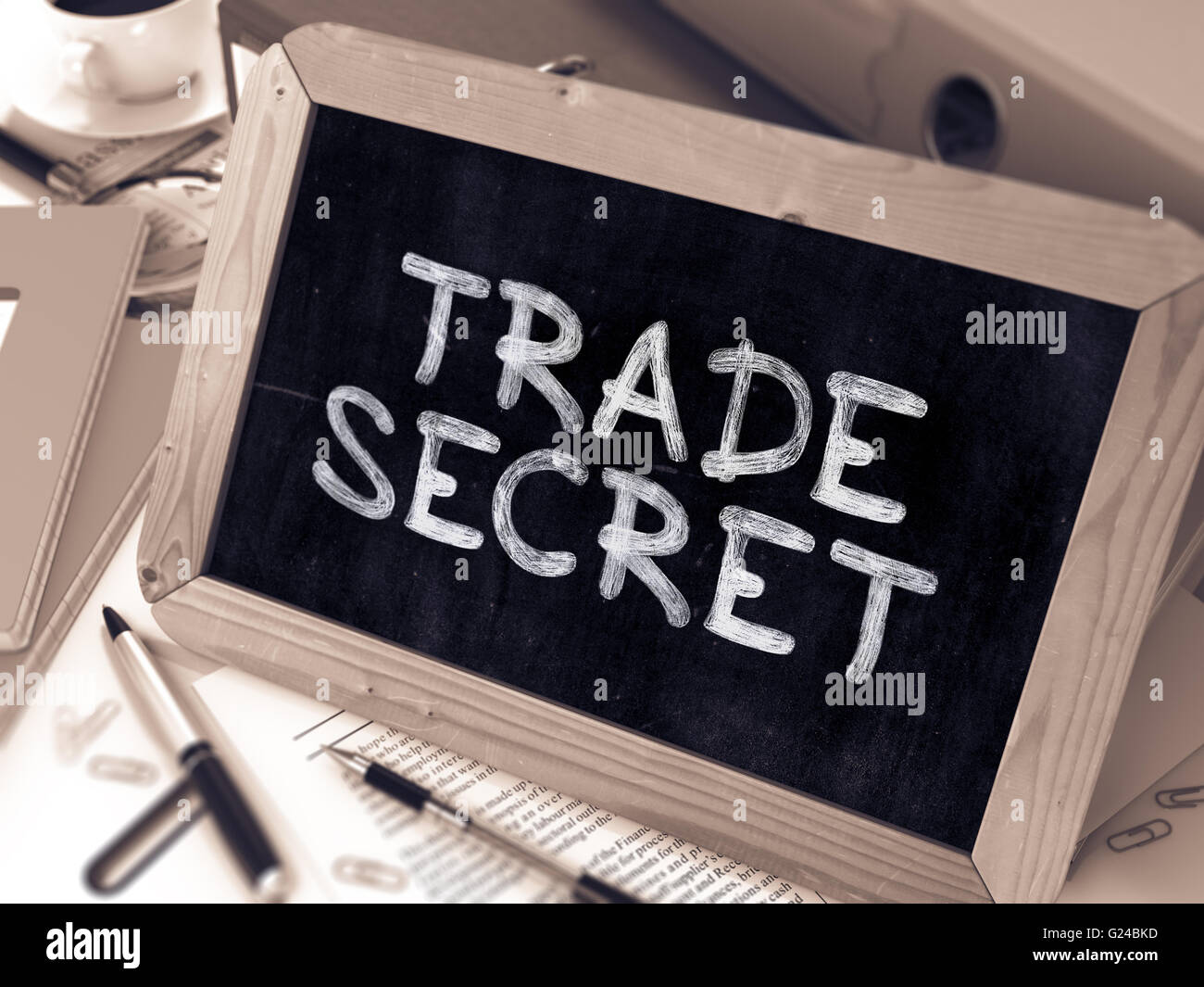 Il segreto commerciale manoscritte da bianco gesso su una lavagna. Foto Stock