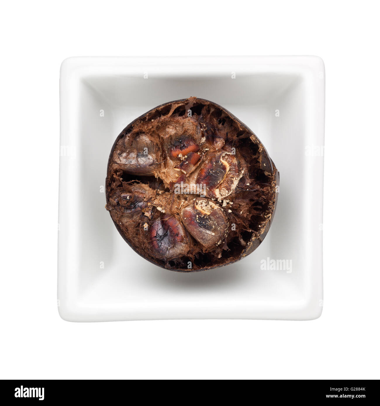 Luo Han Guo in un recipiente quadrato isolato su sfondo bianco Foto Stock