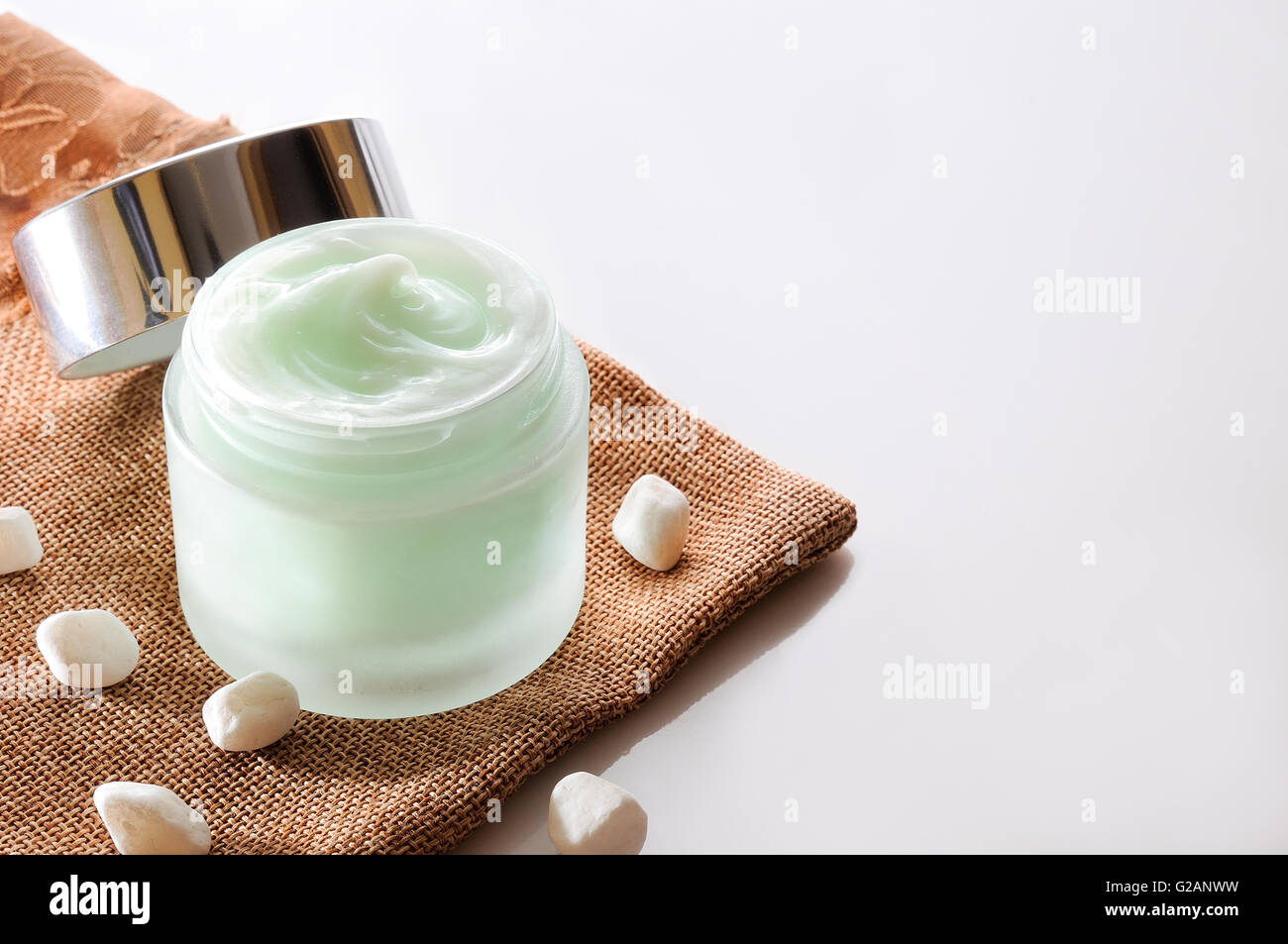 Vasetto di crema aperto su tela top isolato Foto Stock