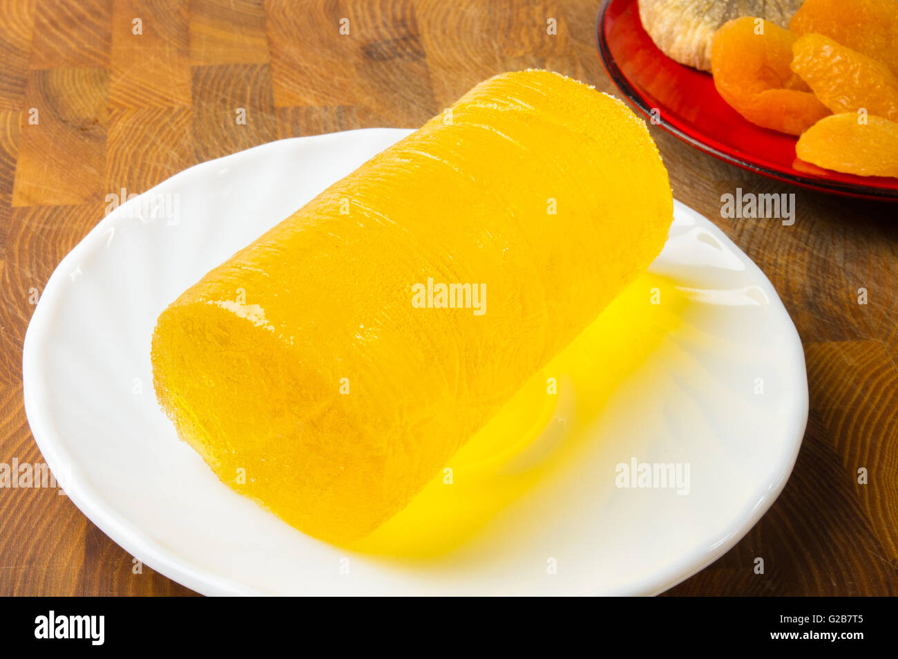 Dieta giallo marmellata su un piattino bianco e frutta secca Foto Stock