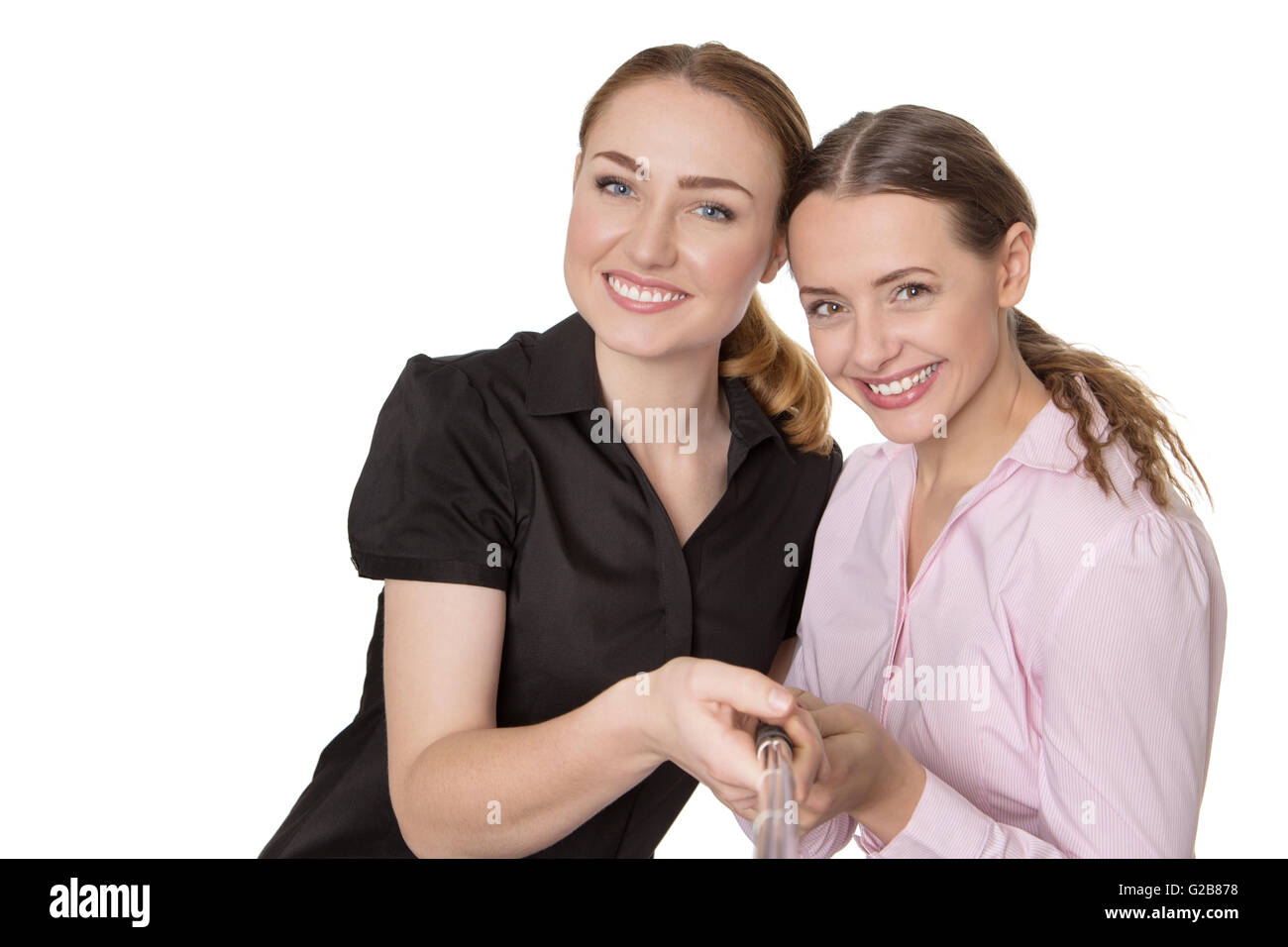 Studio shot di felice due modelli di business che posano per una foto con un bastone selfie. isolato su bianco Foto Stock