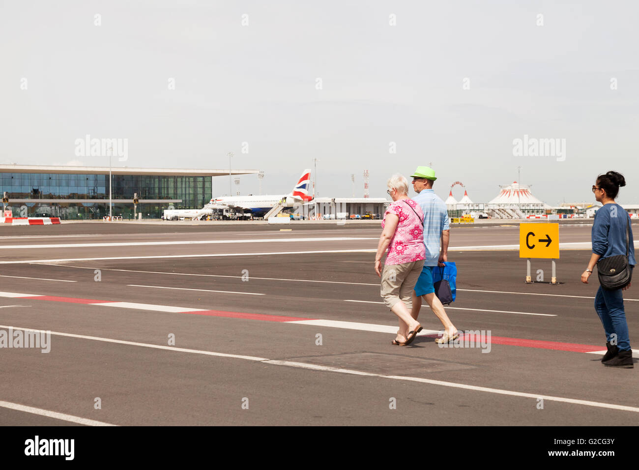 La gente camminare sulla strada perimetrale, aeroporto di Gibilterra Gibilterra in Europa Foto Stock