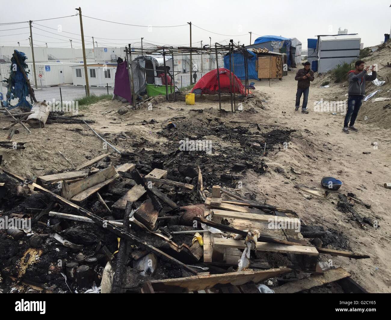 Calais, Francia. 27 Maggio, 2016. Distrutto rifugi di fortuna sono visti nel campo migrante soprannominato "Jungle' nella periferia di Calais, Francia, 27 maggio 2016. Quaranta persone sono rimaste ferite in una rissa al campo profughi, le autorità locali ha detto. Diversi rifugi sono stati bruciati. Foto: Anna Psaroudakis/dpa/Alamy Live News Foto Stock
