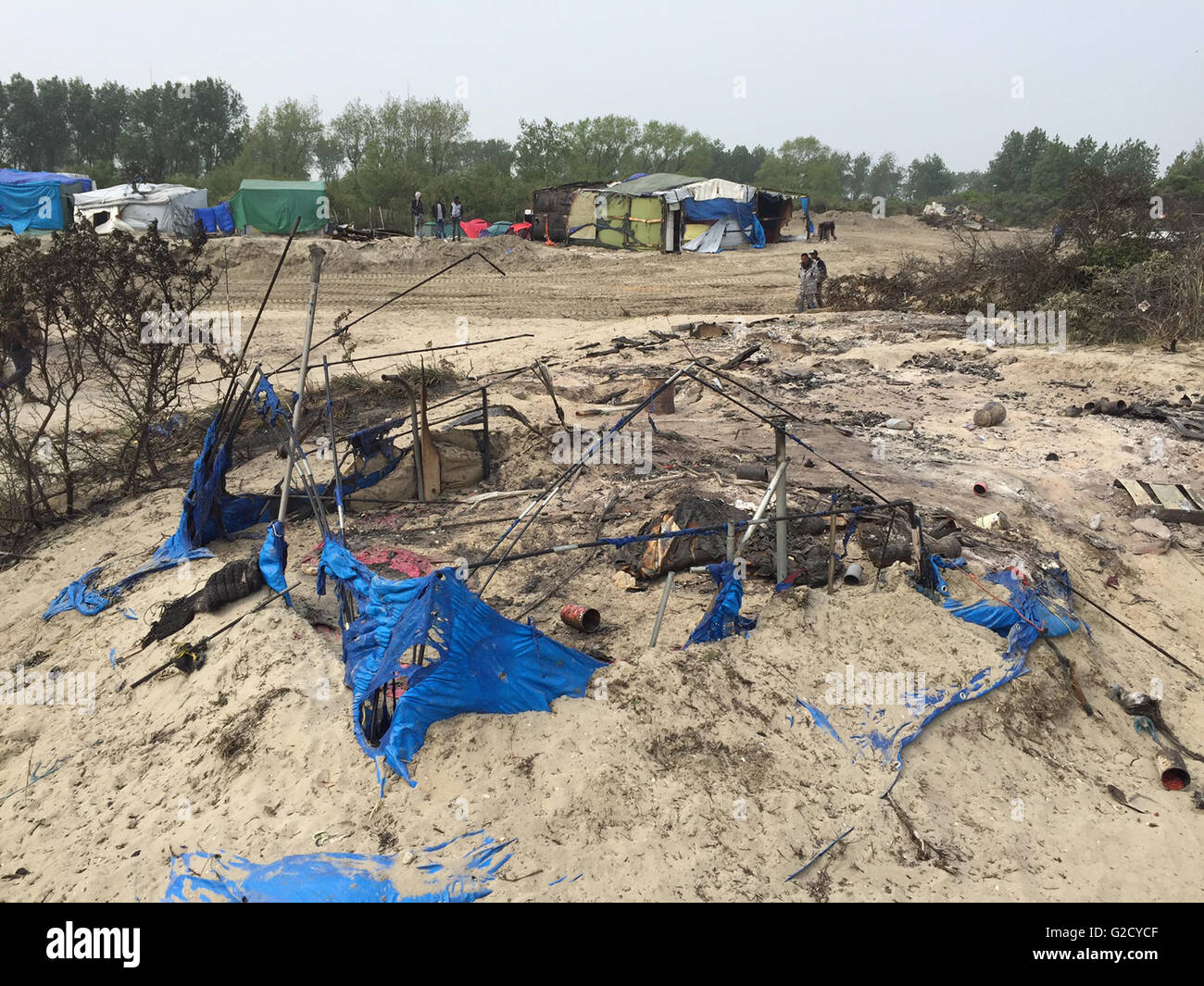 Calais, Francia. 27 Maggio, 2016. Tracce di distruzione sono visti nel campo migrante soprannominato "Jungle' nella periferia di Calais, Francia, 27 maggio 2016. Quaranta persone sono rimaste ferite in una rissa al campo profughi, le autorità locali ha detto. Diversi rifugi sono stati bruciati. Foto: Anna Psaroudakis/dpa/Alamy Live News Foto Stock