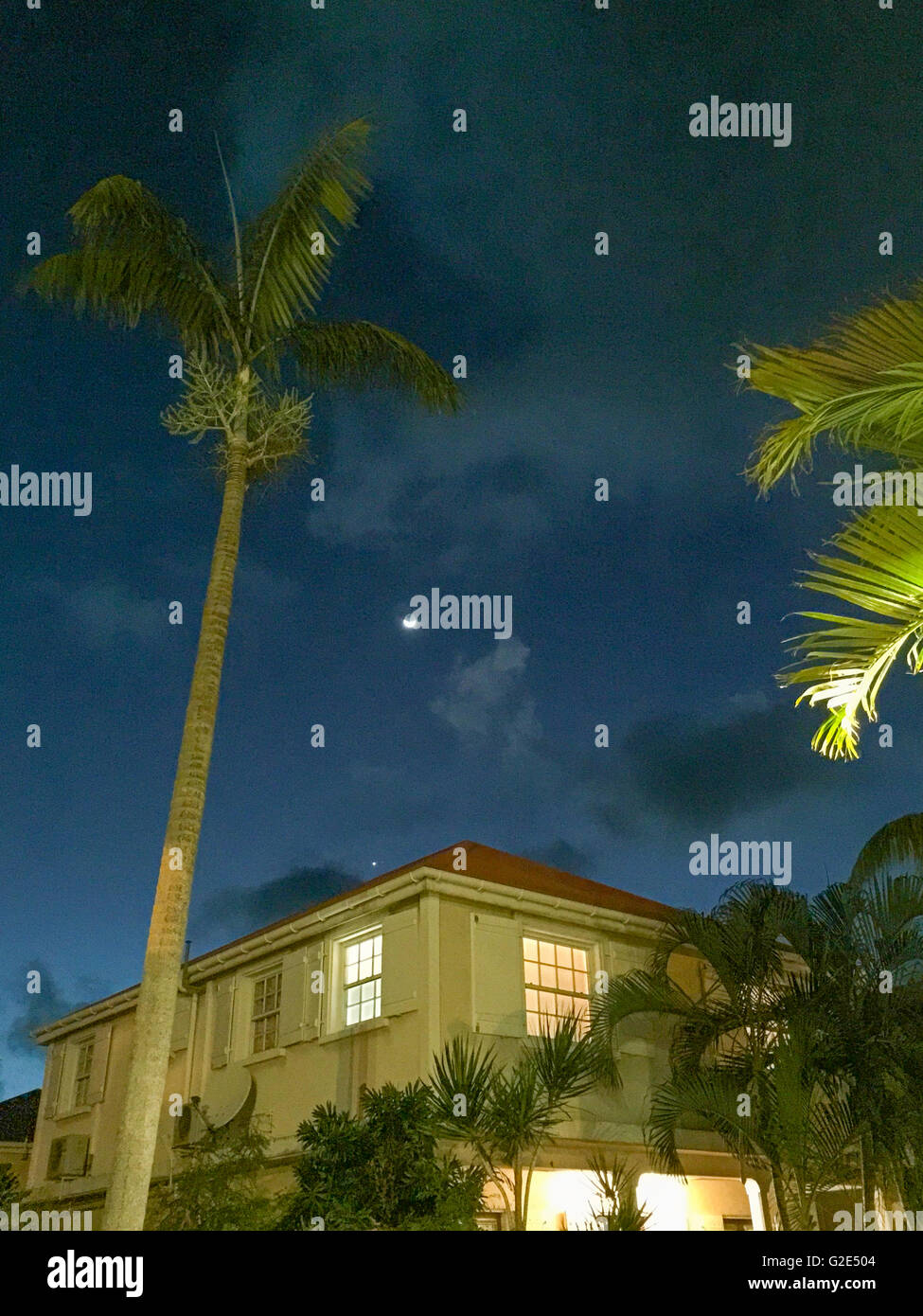 Inizio del cielo della sera con il vecchio st bart home e le palme in gustavia Foto Stock
