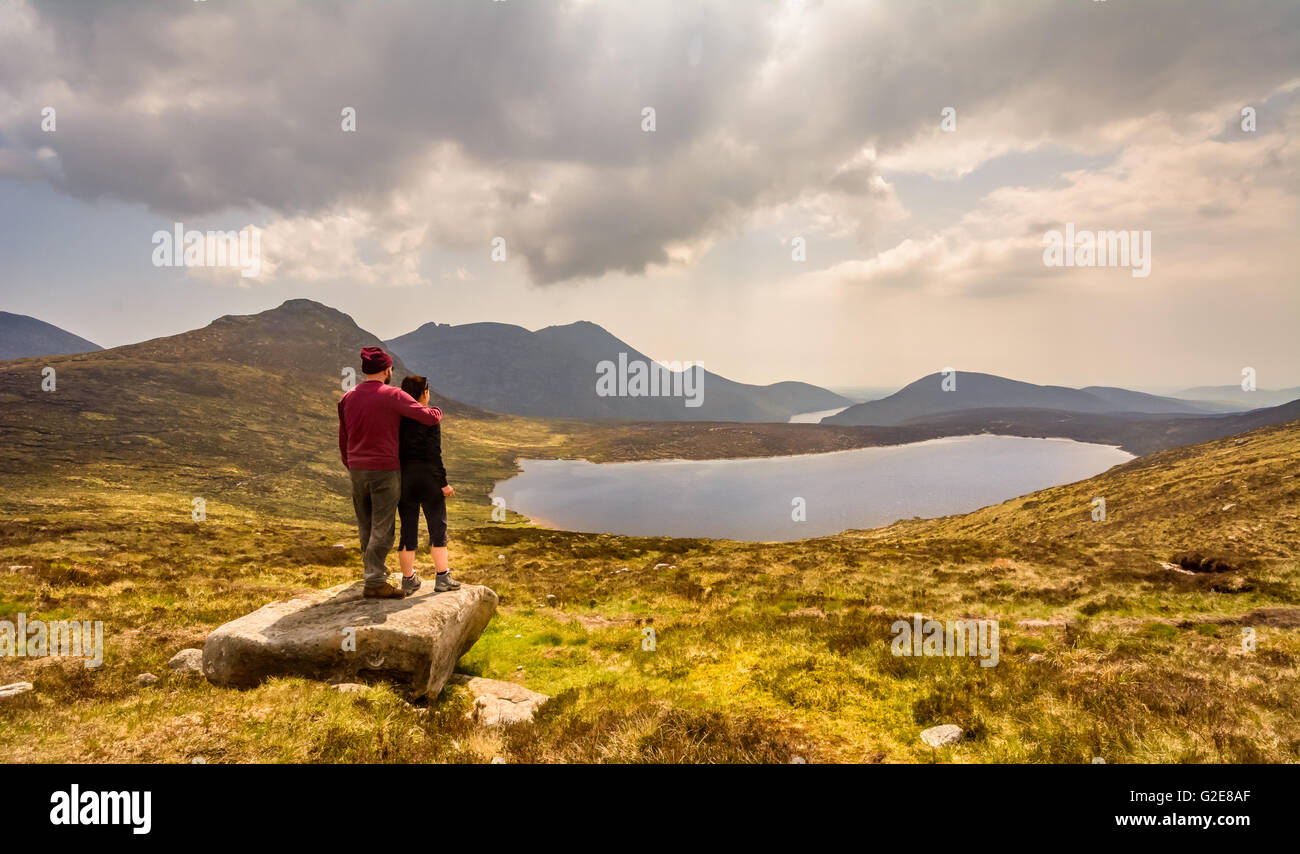 Coppia giovane lo sguardo oltre la Mourne Mountain Range nella contea di Down, Irlanda. Foto Stock