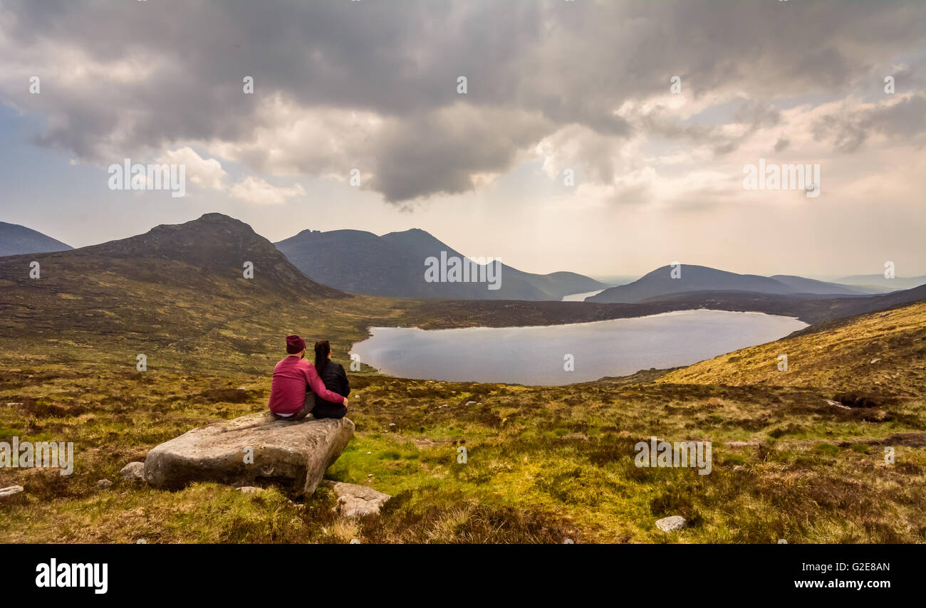 Coppia giovane lo sguardo oltre la Mourne Mountain Range nella contea di Down, Irlanda. Foto Stock