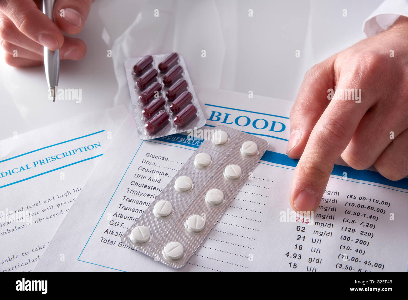 Medico di prescrivere farmaci e sangue che mostra il rapporto di prova con i documenti e le medicine su un bianco tavolo di vetro. Posizione orizzontale Foto Stock