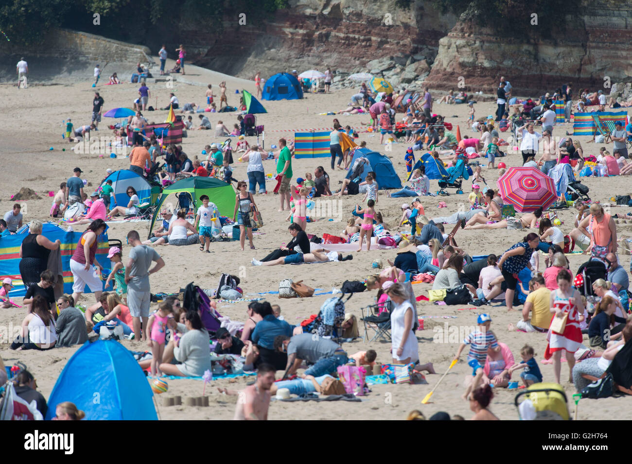 Un pranzo spiaggia affollata a Whitmore Bay, Barry Island, nel Galles del Sud, su un calde estati soleggiate giorno. Foto Stock