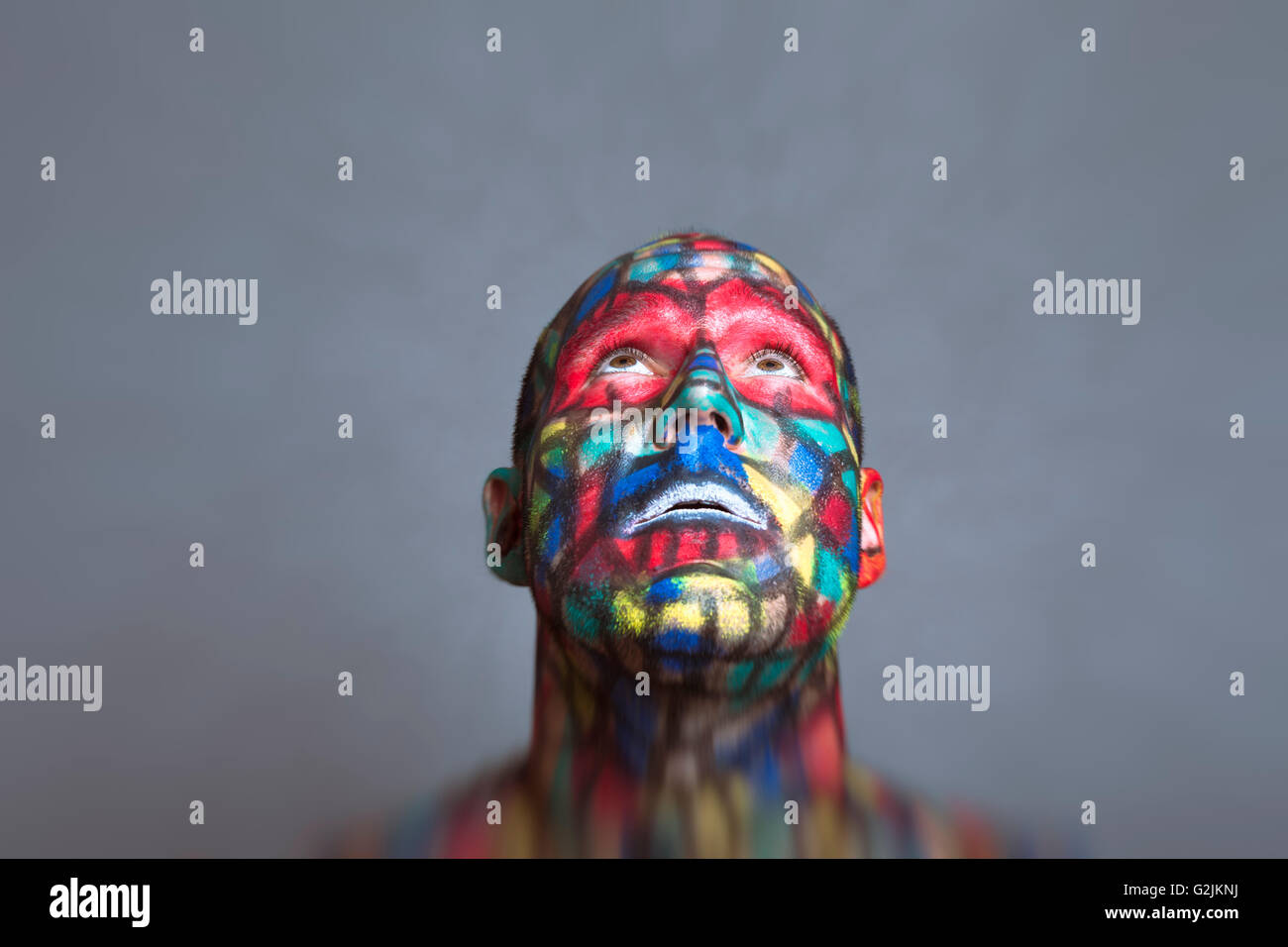 Il supereroe che guardando in alto, faccia colorata arte con tilt shift e motion blur effetto. Foto Stock