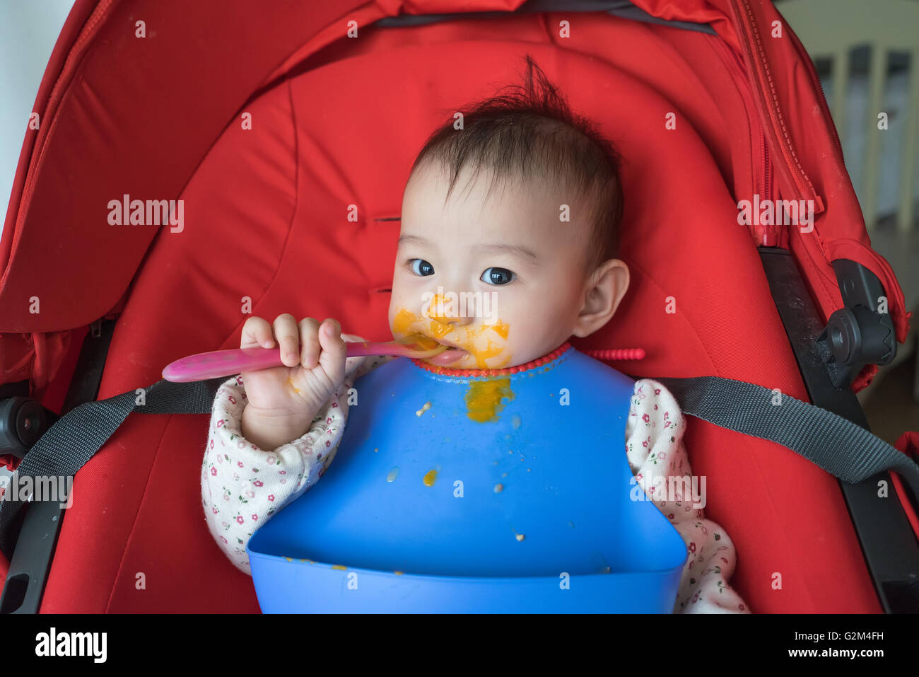 Un anno di età del bambino di mangiare da soli Foto Stock