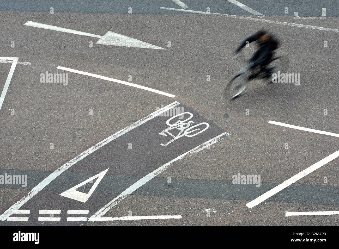 Ciclista utilizzando piste ciclabili su strada. Foto Stock
