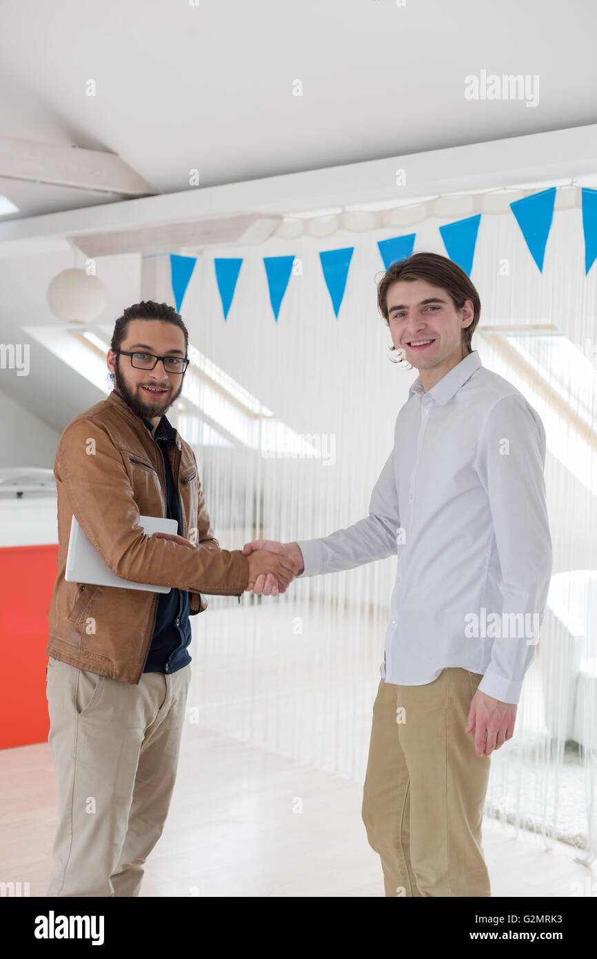 Businesss e concetto di ufficio - due imprenditori stringono le mani in office Foto Stock