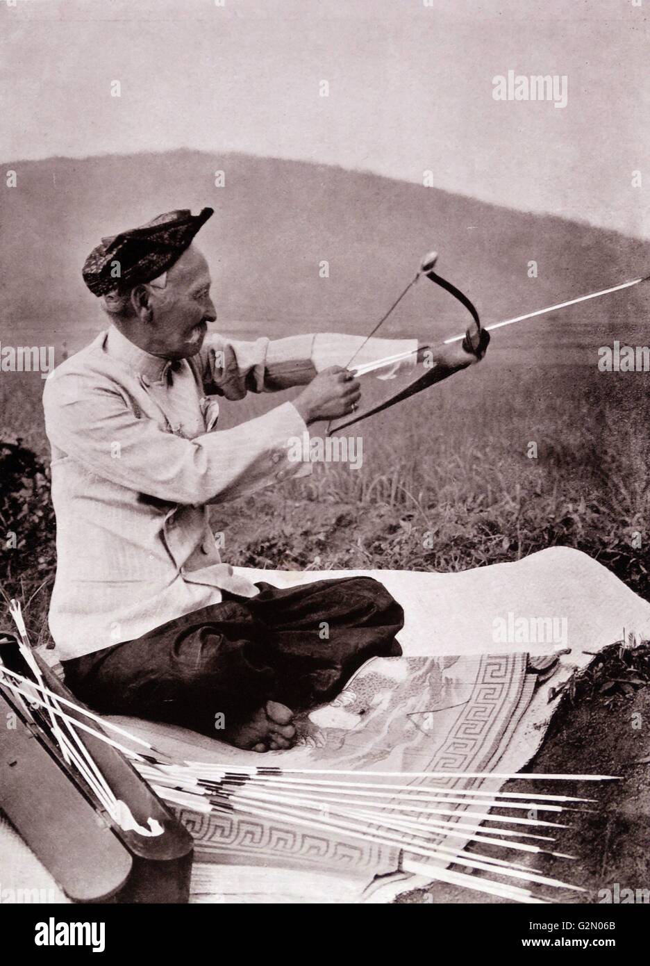 La fotografia mostra un vecchio maschio di test di un arco e frecce in un campo. Le Indie orientali olandesi, noto come Indonesia moderna. Datata c1935. Foto Stock