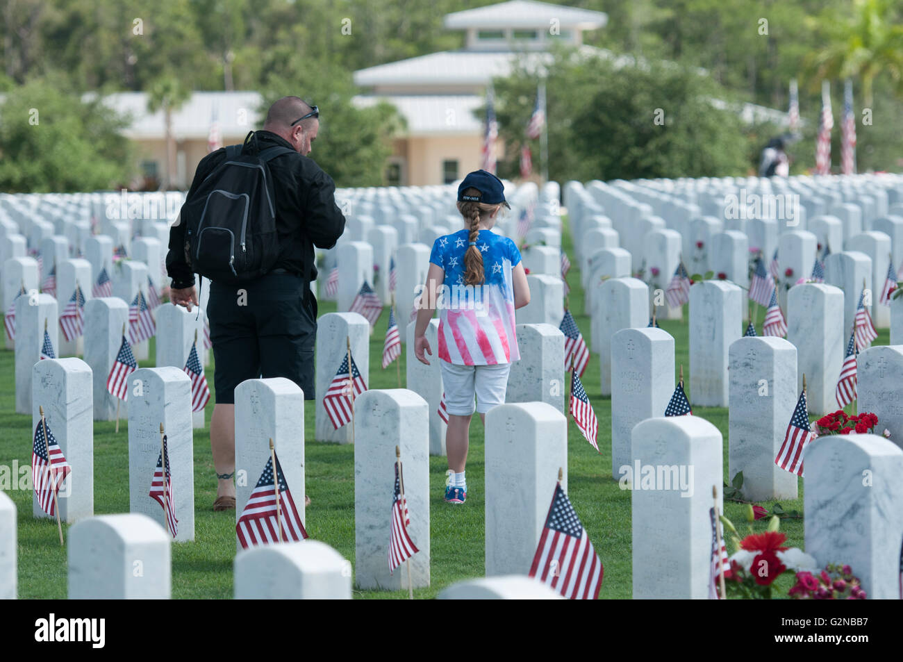 Una ragazza e il padre di visitare le tombe dei veterani di guerra del Memorial Day. Foto Stock