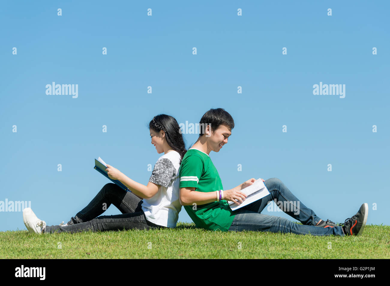 Close-up di attraente coppia giovane in una libreria a leggere un libro  insieme con altre persone e scaffali in background Foto stock - Alamy