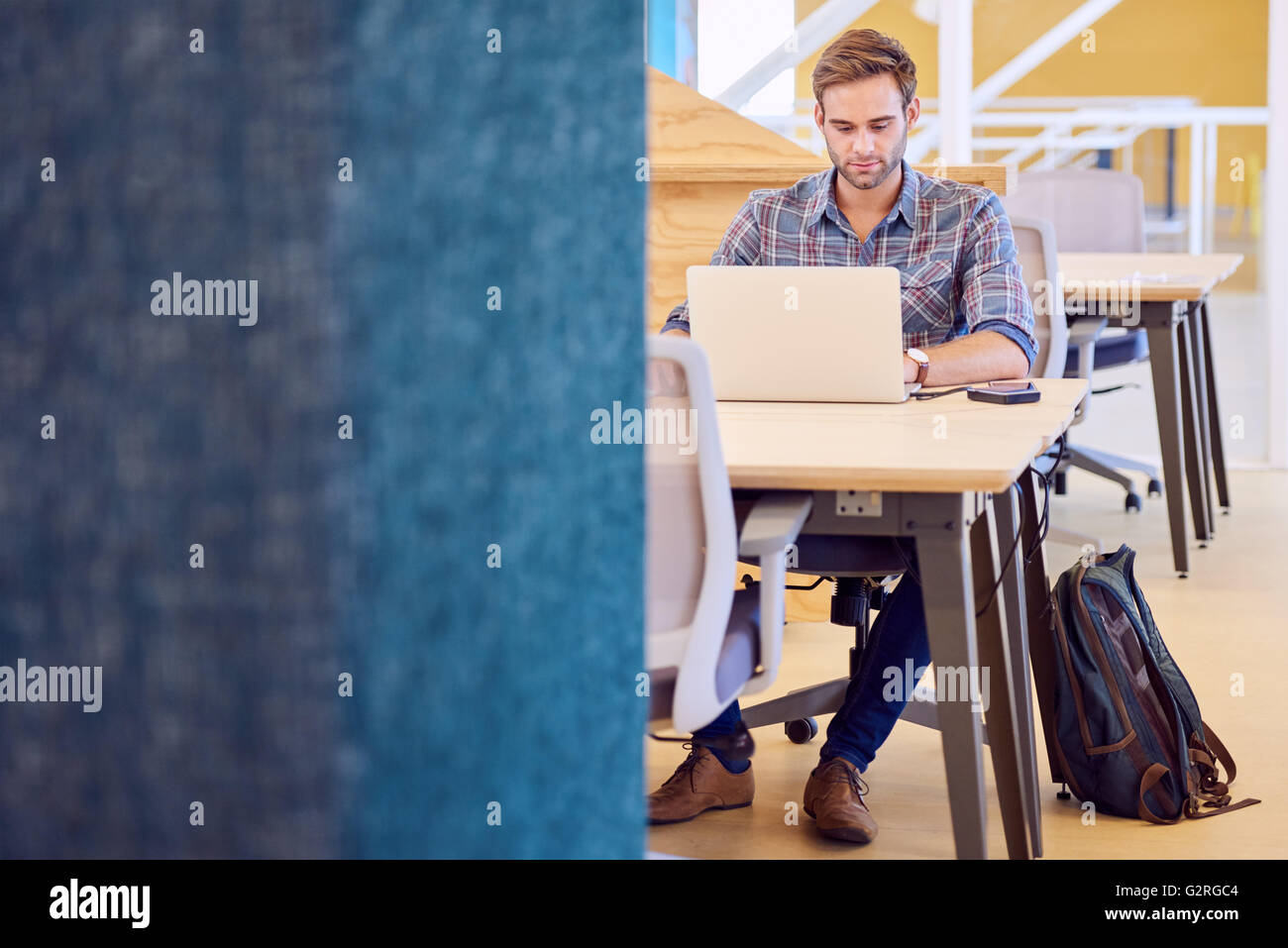 Maschio adulto di imprenditore in un duro lavoro sul suo computer portatile Foto Stock