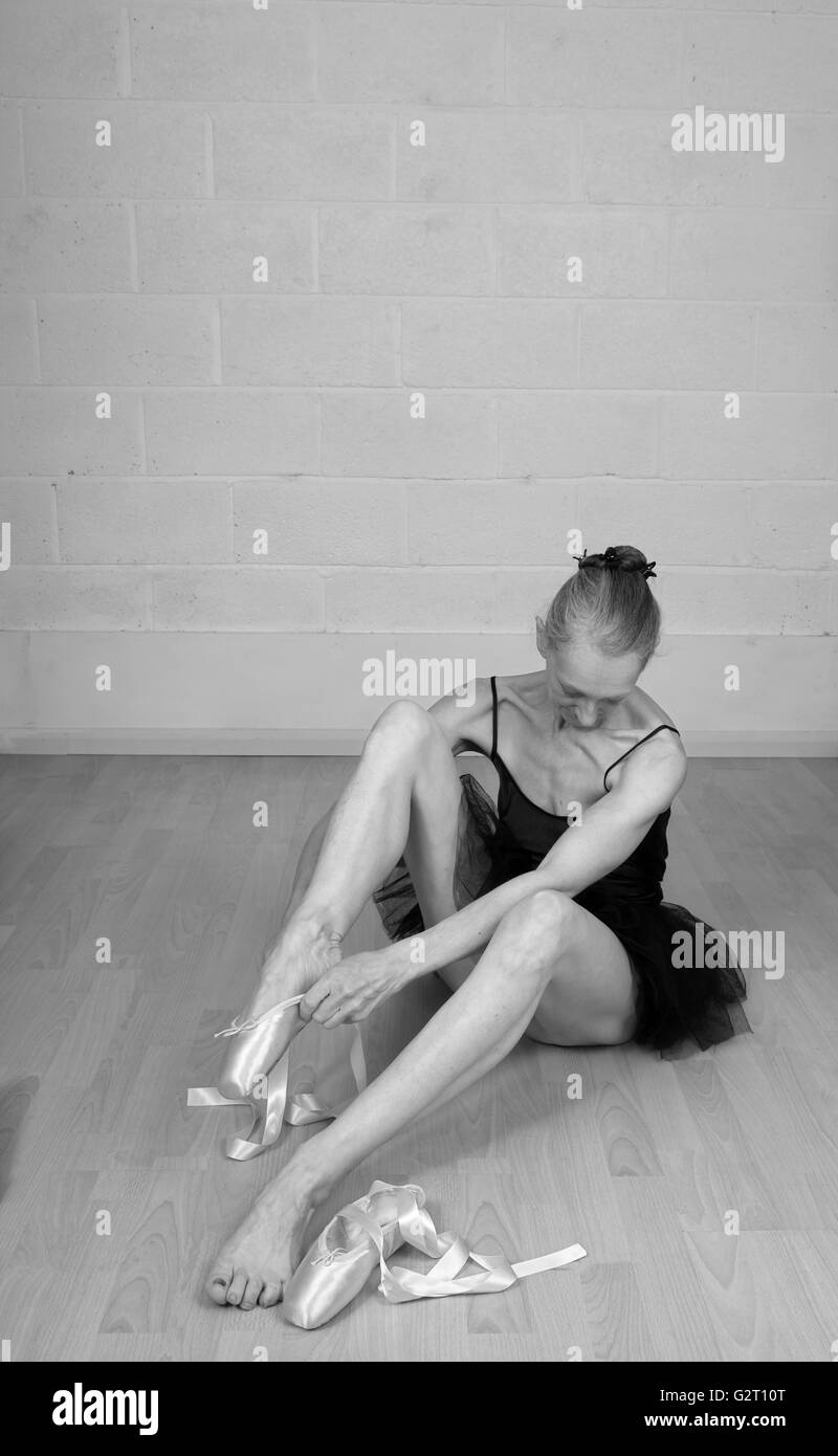 Invecchiamento della ballerina medicazione in suo punto scarpe, indossando solo un tutu. Il 31 maggio 2016 Foto Stock
