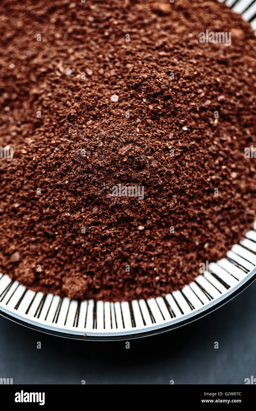 Fresco intero di caffè in grani e macinato di caffè sulla piastra Foto Stock