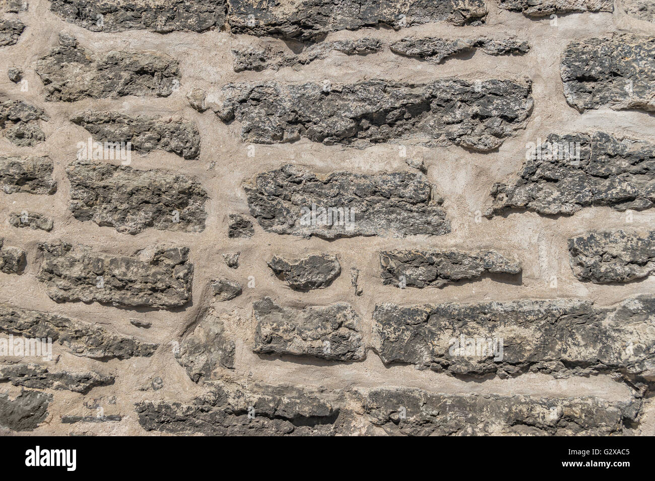 Dettagli di un vecchio grigio muro di pietra Foto Stock