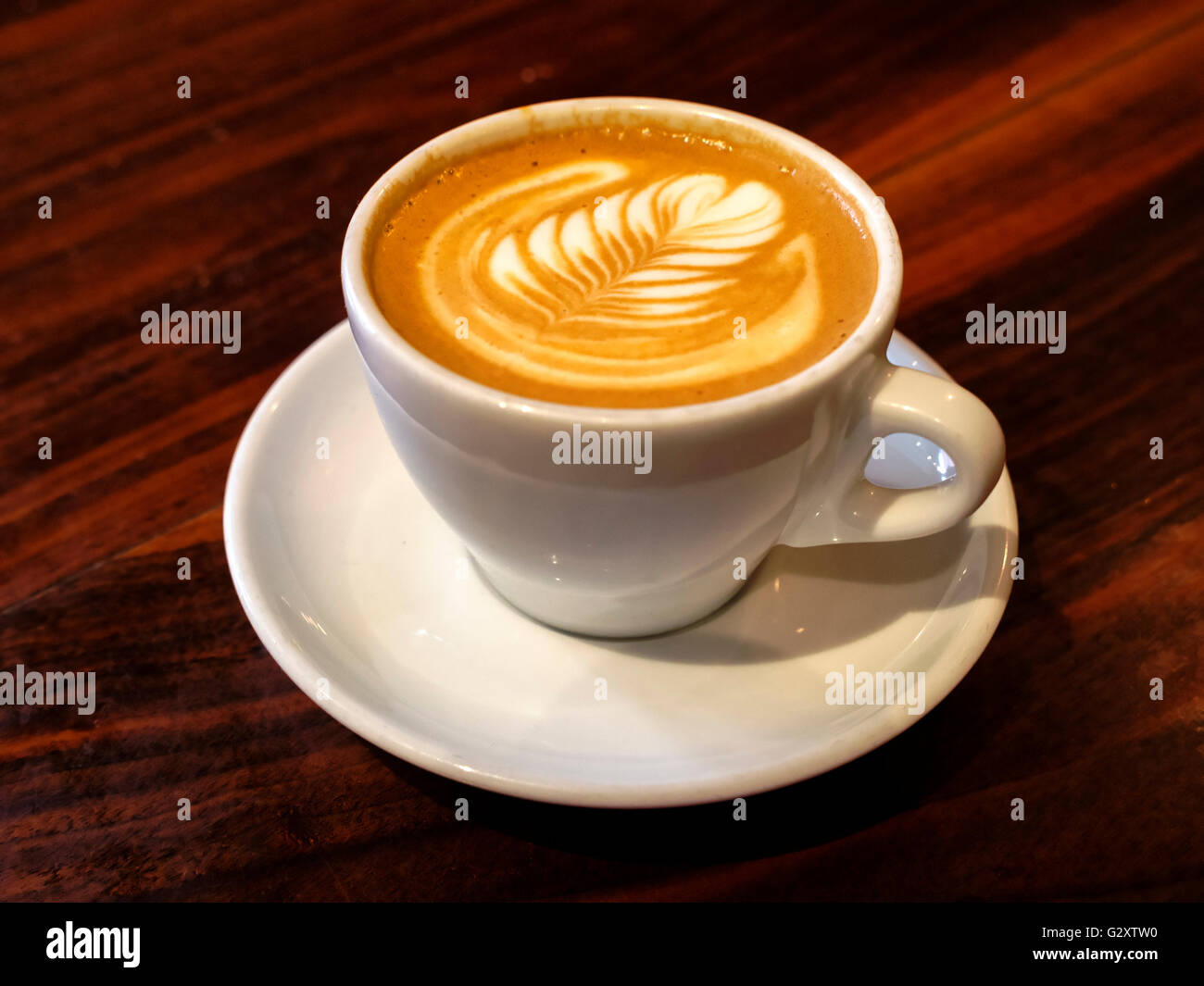 Il Cappuccino in una tazza bianca con piattino Foto Stock