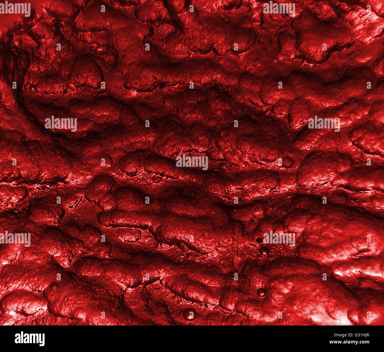 Uno sfondo rosso texture con una strana consistenza e design con piccole bolle. Foto Stock