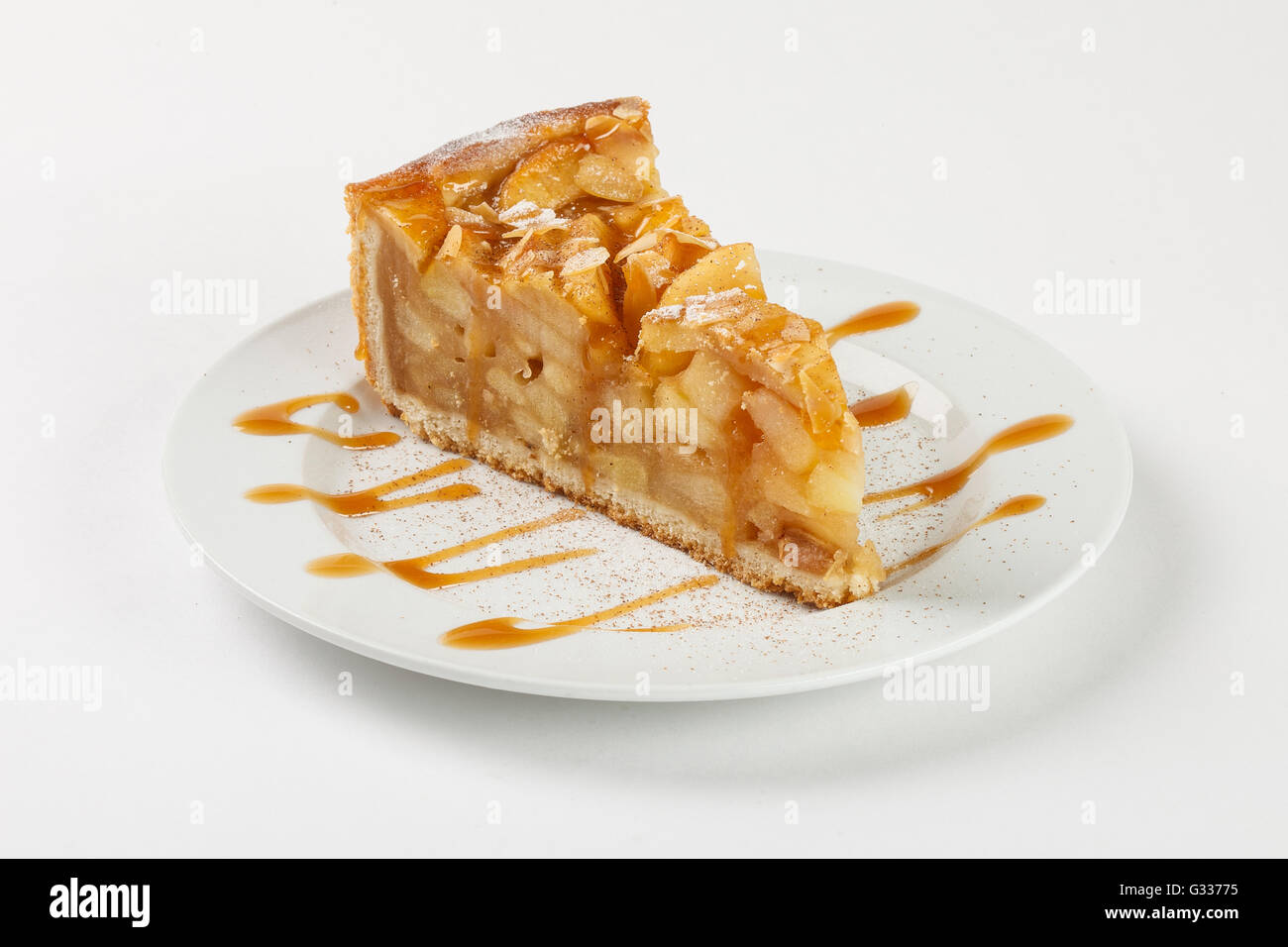 Una deliziosa torta di mele charlotte al caramello sulla piastra su sfondo bianco. Chiudere fino in vista laterale. Foto Stock