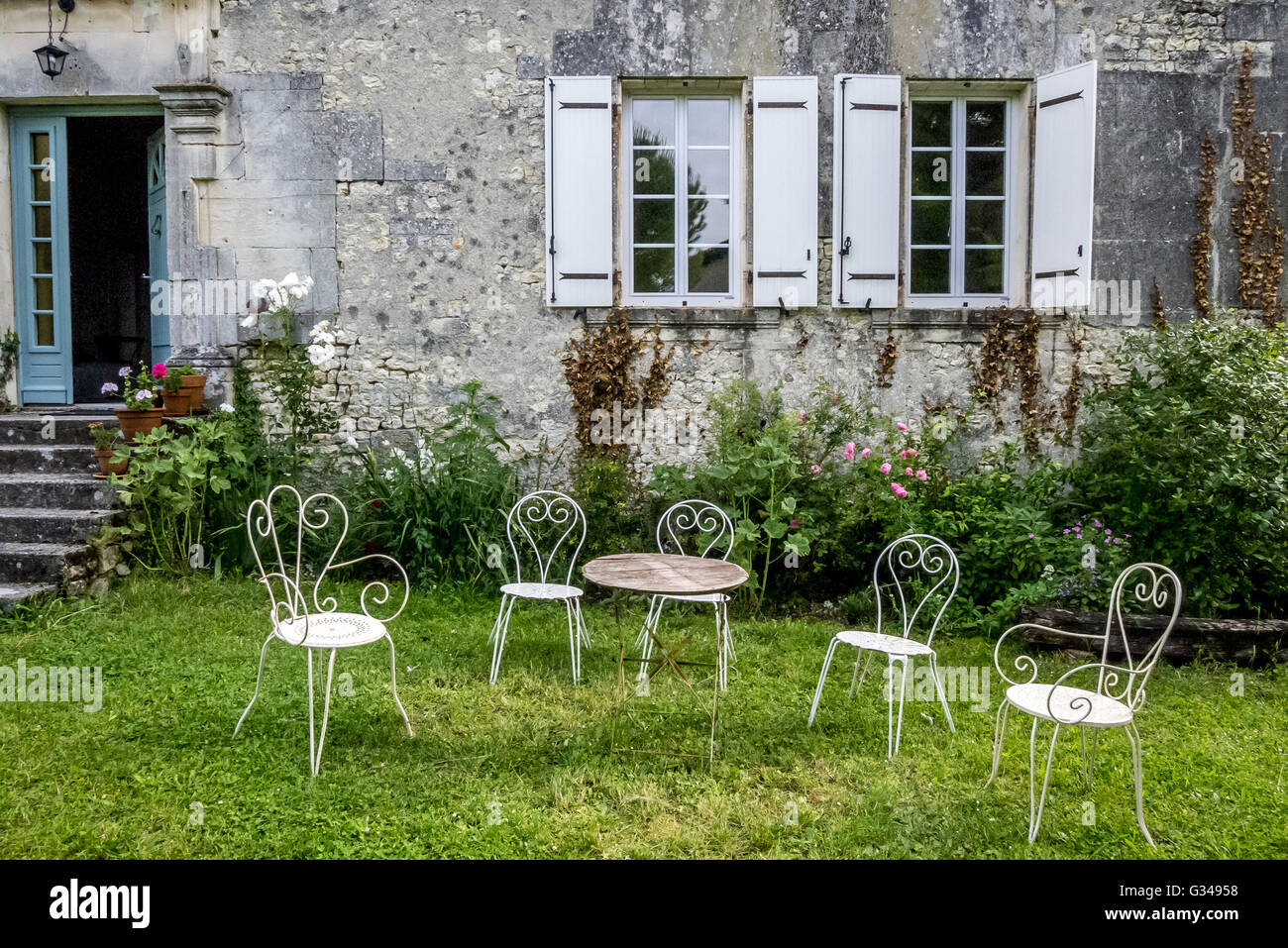 Tavolo e sedie al di fuori di una casa colonica francese Foto Stock